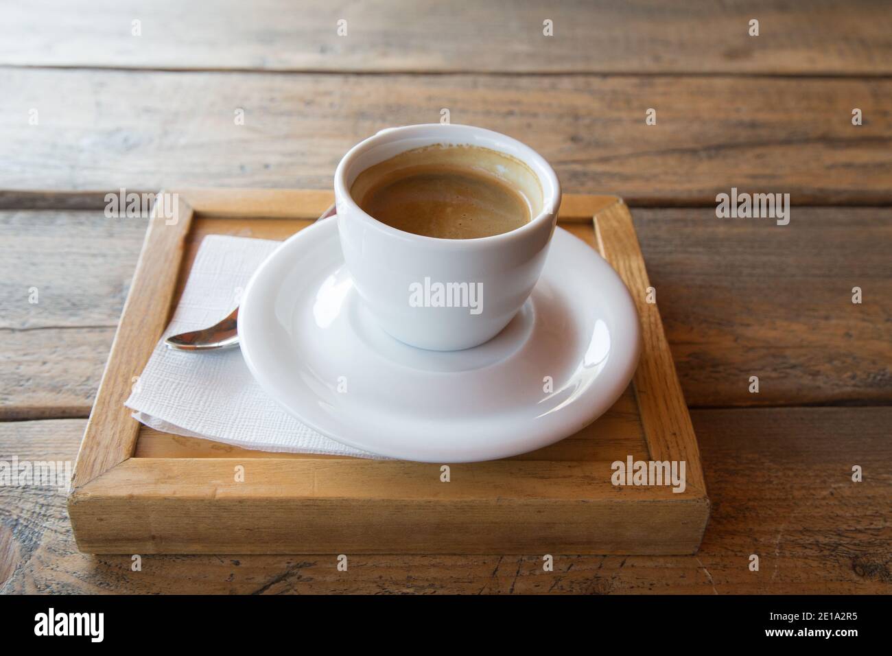 Cup of coffee on a wooden table. Close-up. Stock Photo