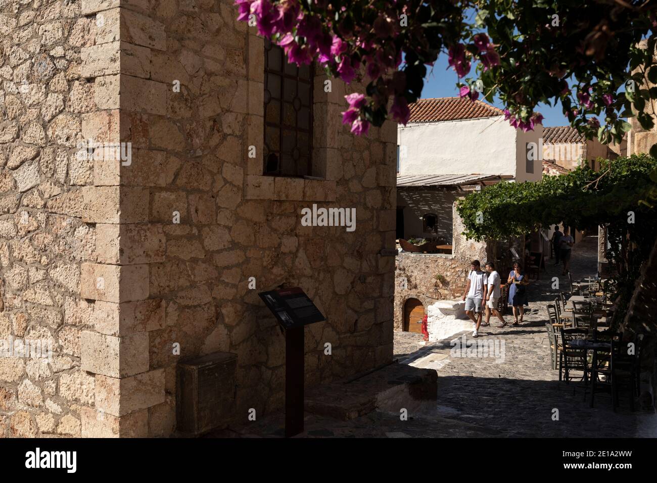 Tourists walk in the castle city of Monemvasia island, Peloponnese region, Greece on July 29, 2020. Stock Photo