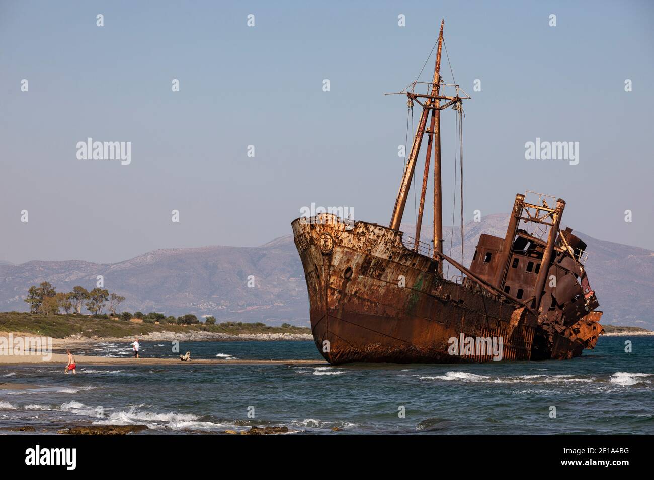 Tourists walk next to the shipwreck «Dimitrios» in Gytheio, Peloponnese region, Greece on July 29, 2020. / Τουρίστες στο ναυάγιο «Δημήτριος», Γύθειο, Stock Photo