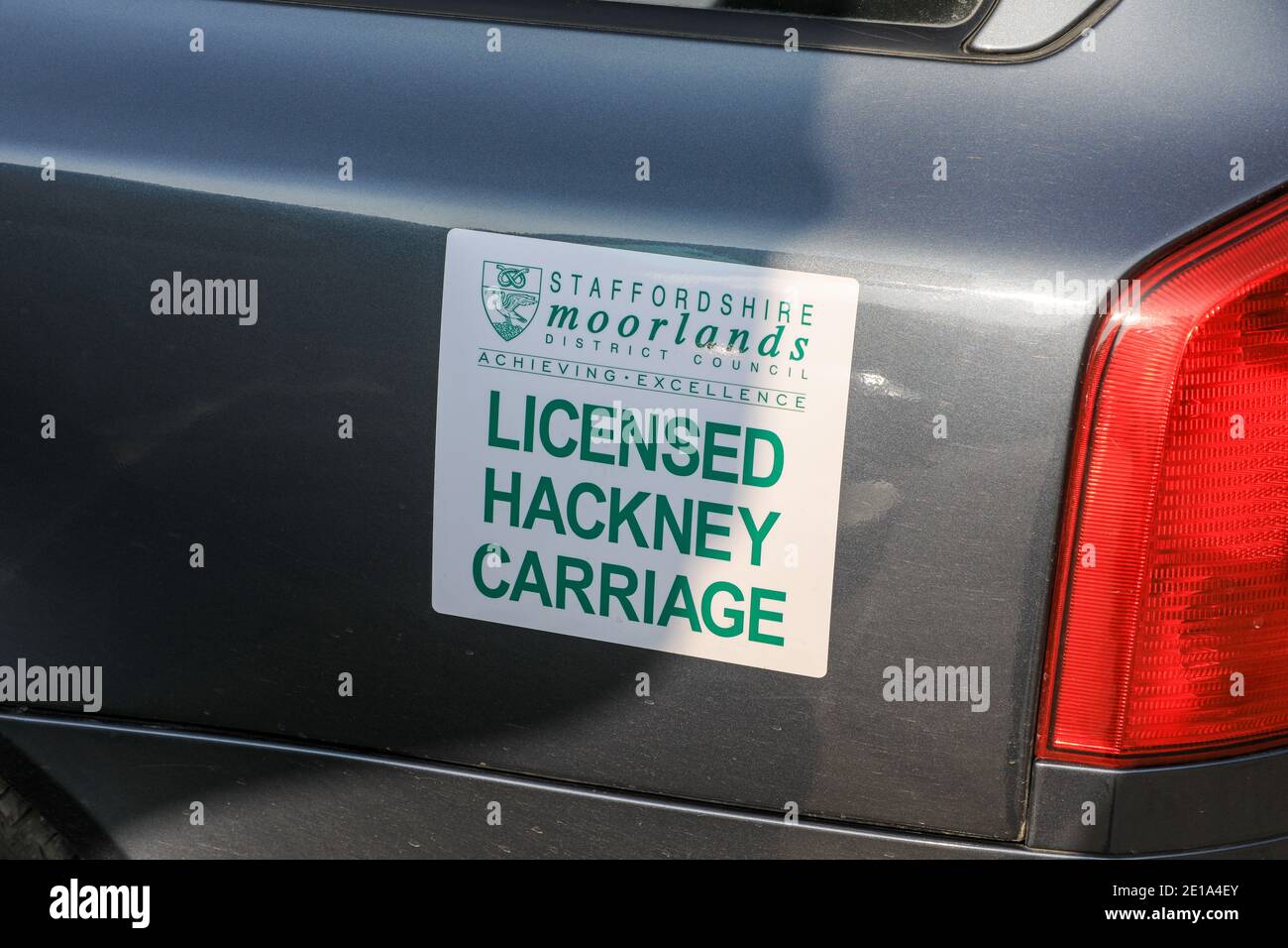 A sign on a taxi or taxi cab saying 'licensed hackney carriage', Staffordshire, England, UK Stock Photo