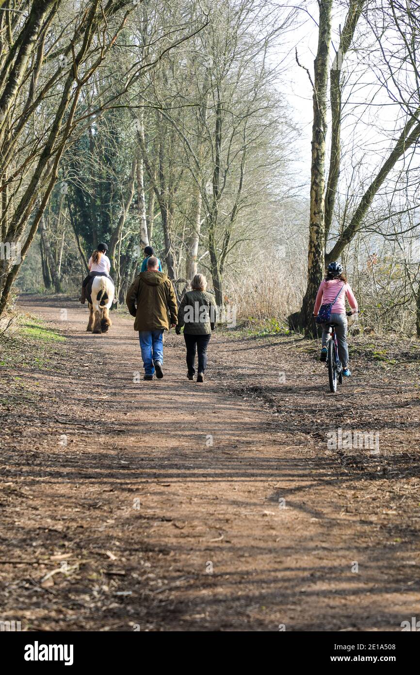 The conflict of horse riders, cyclists and walkers using the same path on the old Churnet railway line at Oakamoor, Staffordshire, England, UK Stock Photo