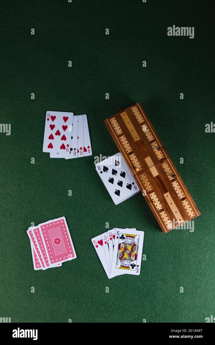 Playing cards and a cribbage board with pegs Stock Photo Alamy