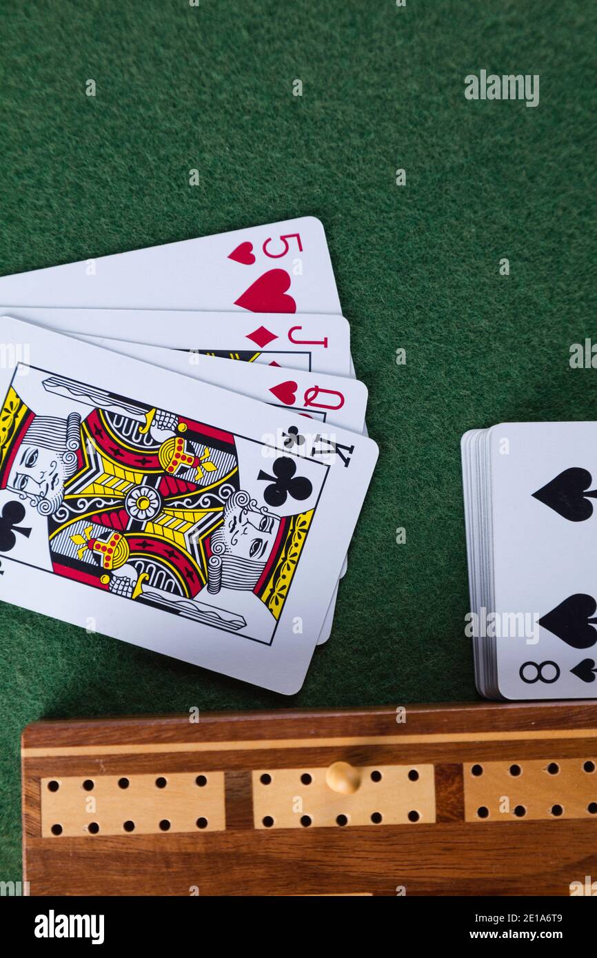 Playing cards and a cribbage board with pegs Stock Photo Alamy