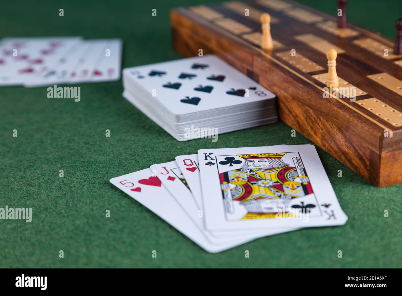 Playing cards and a cribbage board with pegs Stock Photo Alamy