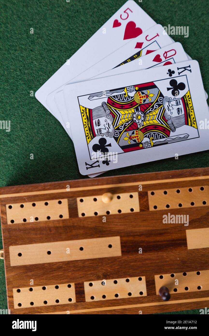 Playing cards and a cribbage board with pegs Stock Photo Alamy