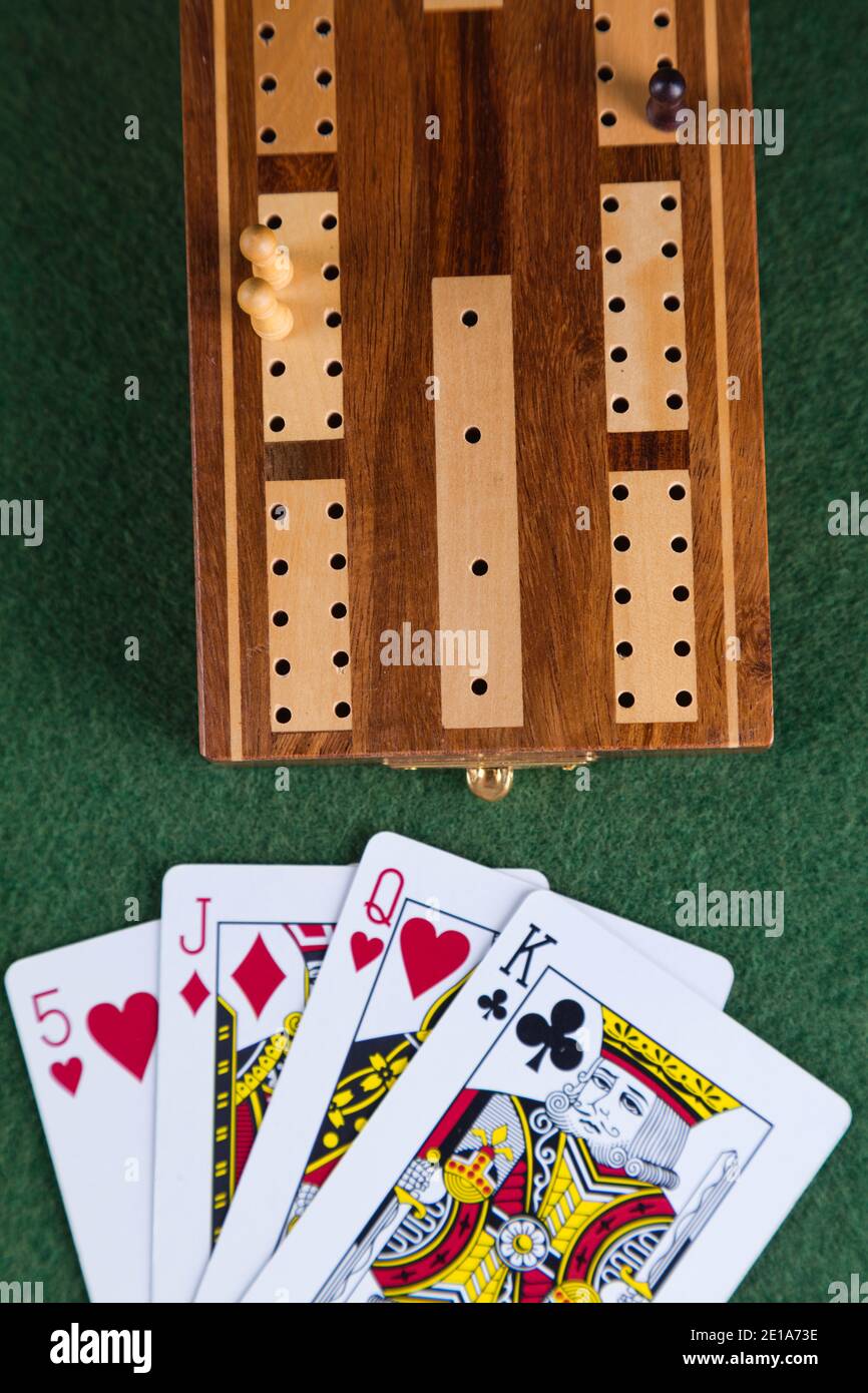 Playing cards and a cribbage board with pegs Stock Photo Alamy