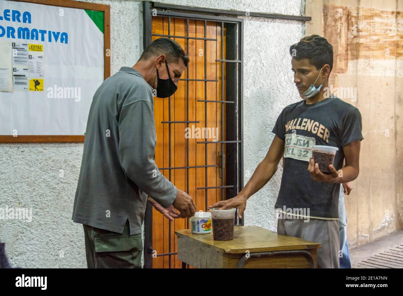 Through a numbering system, all people who require food are given a number, and then removed from their food supply. The solidarity pot is a social pr Stock Photo