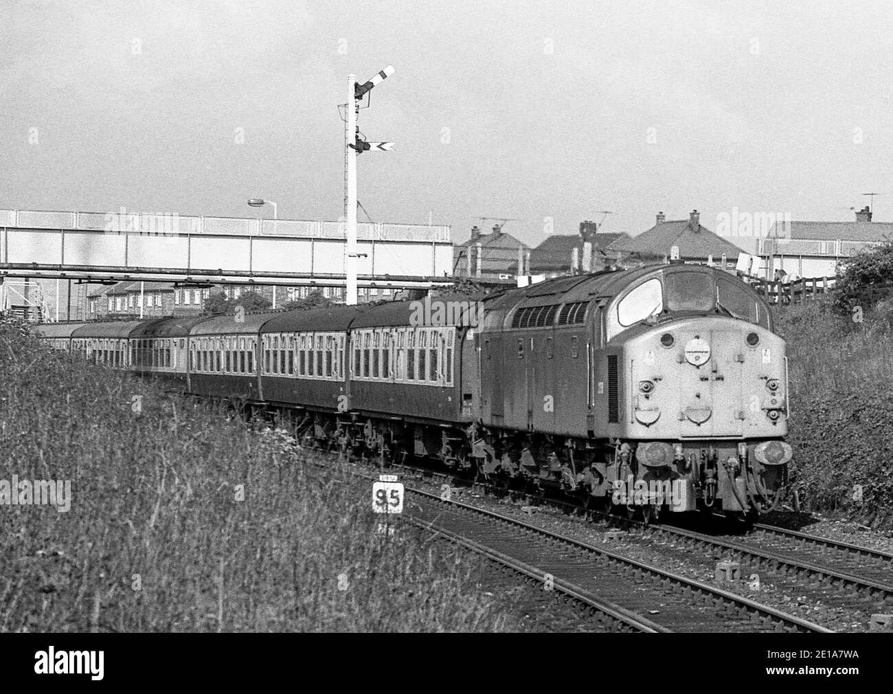 A British Rail class 40 diesel locomotive hauling a passenger train past Brockley Whins, South Tyneside, England, UK in the late 1960s. Stock Photo