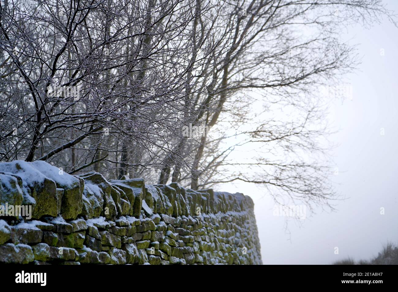 Dry stone wall in the snow Stock Photo
