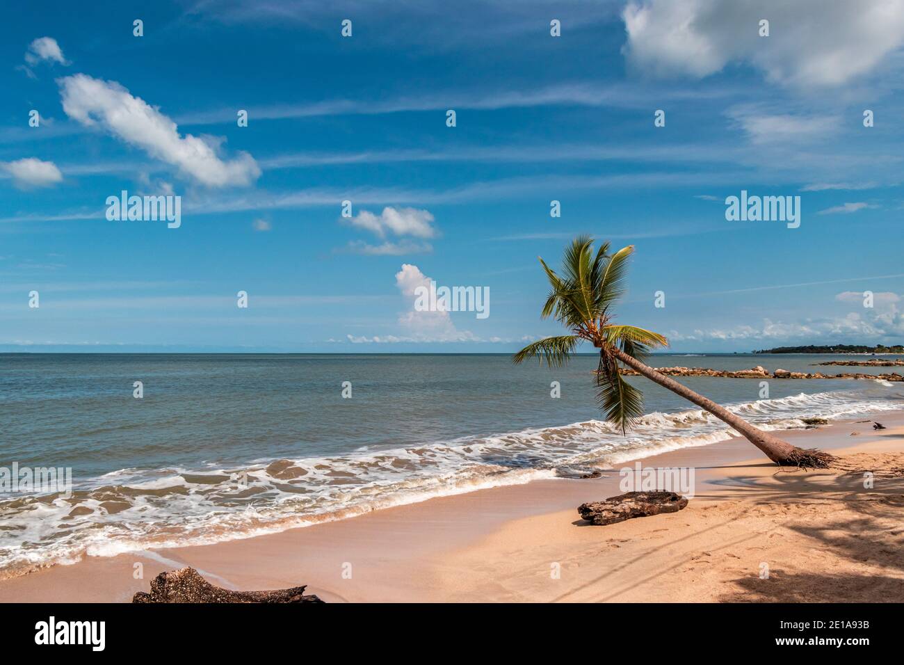 A beautiful sight of a tropical beach landscape, the sun is just rising in a wonderful and colorful sunrise Stock Photo