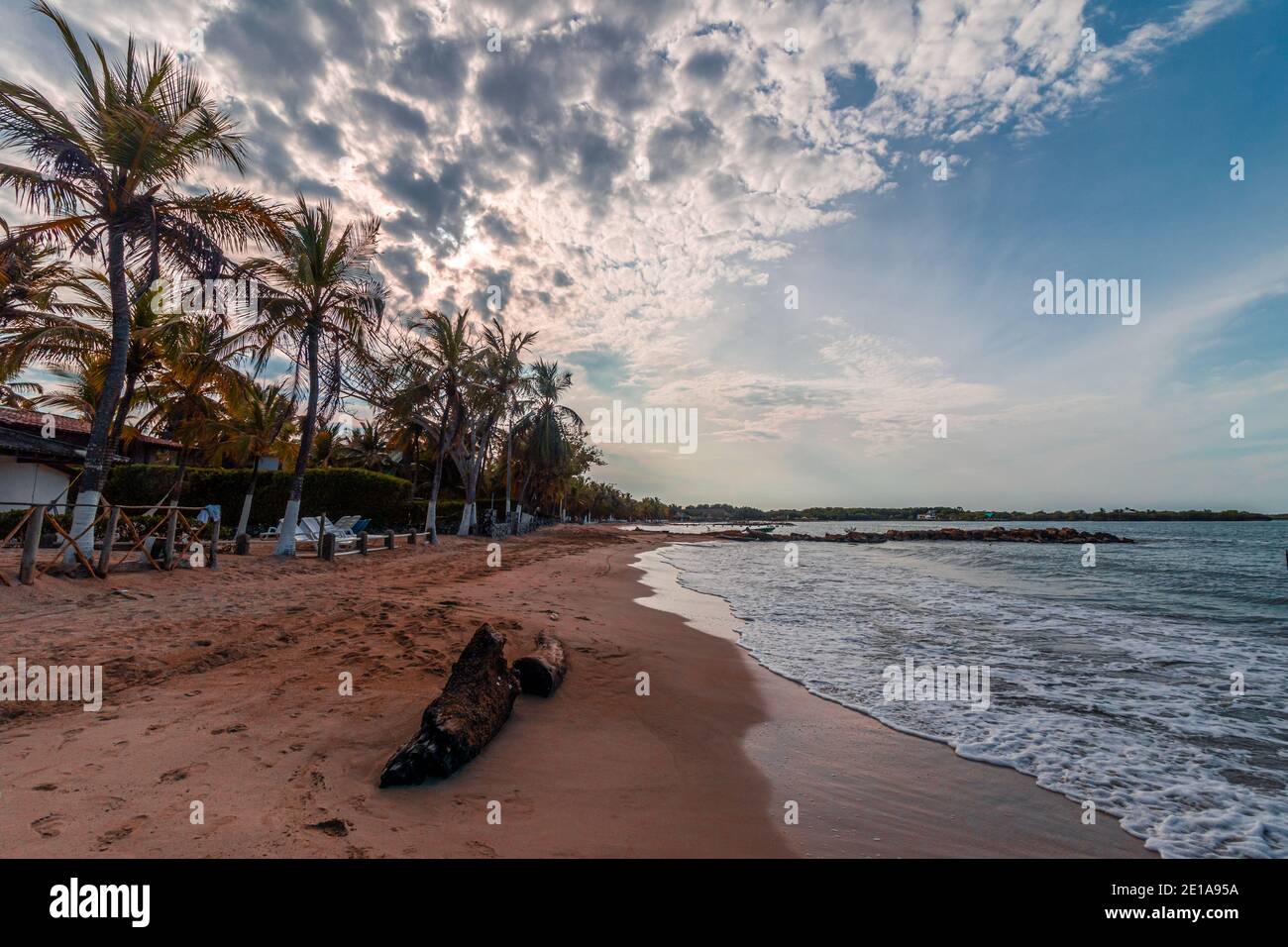 A beautiful sight of a tropical beach landscape, the sun is just rising in a wonderful and colorful sunrise Stock Photo