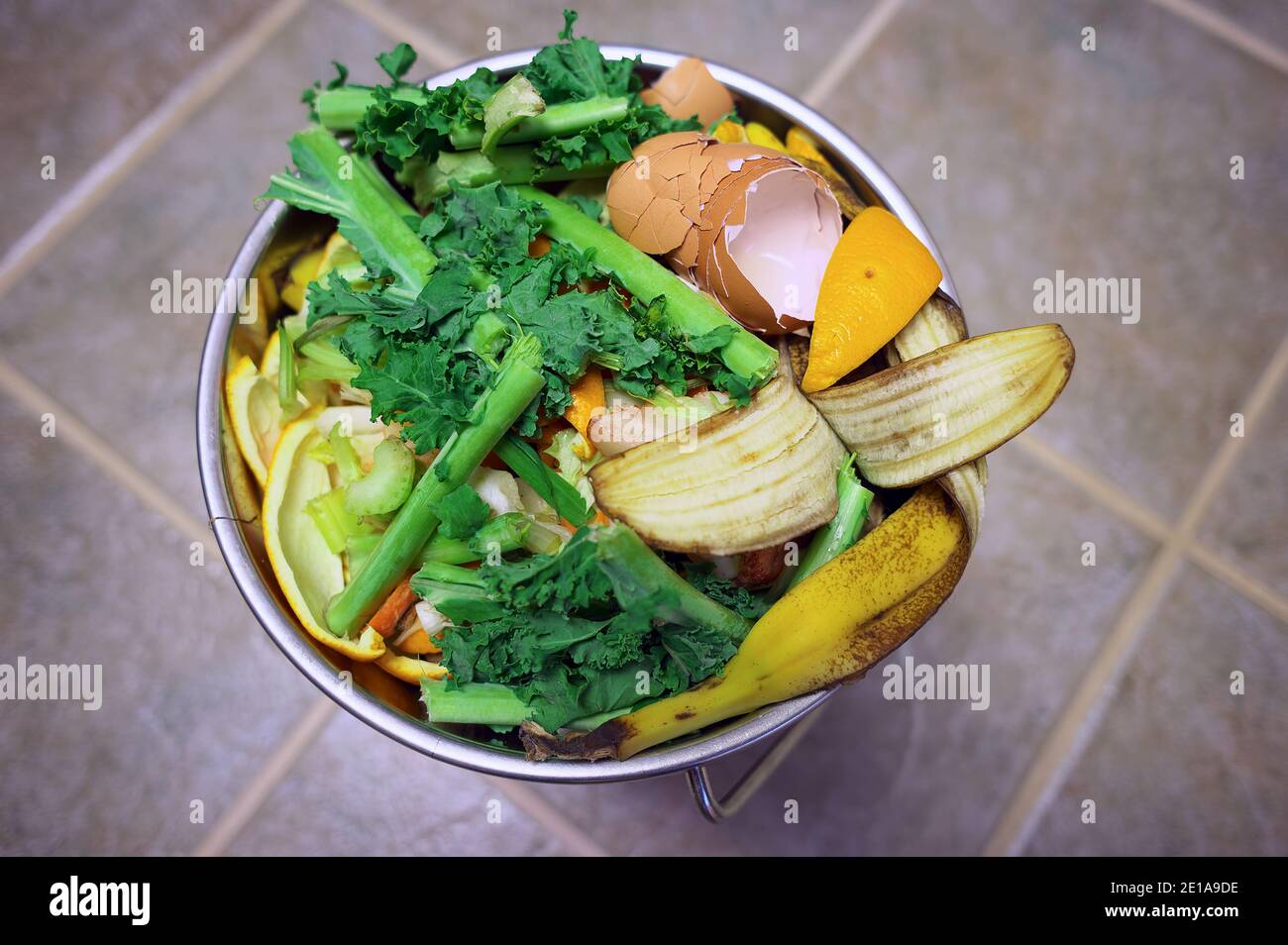 Compost pail of colourful kitchen scraps ready to be composted. Stock Photo