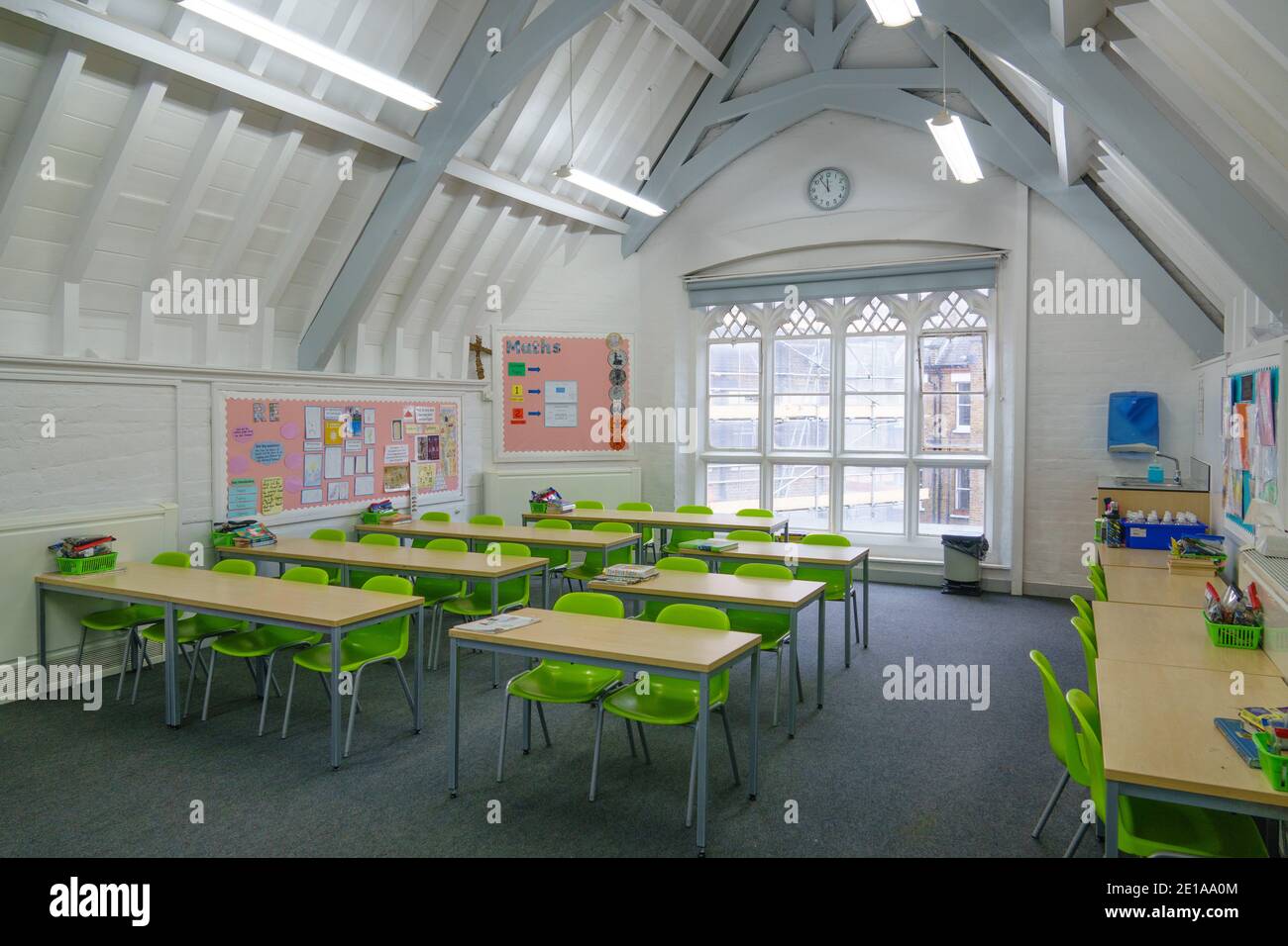 Typical primary / middle school classroom in the UK with desks and chairs in rows. Schools closed in lockdown but prepared for reopening in March 2021 Stock Photo