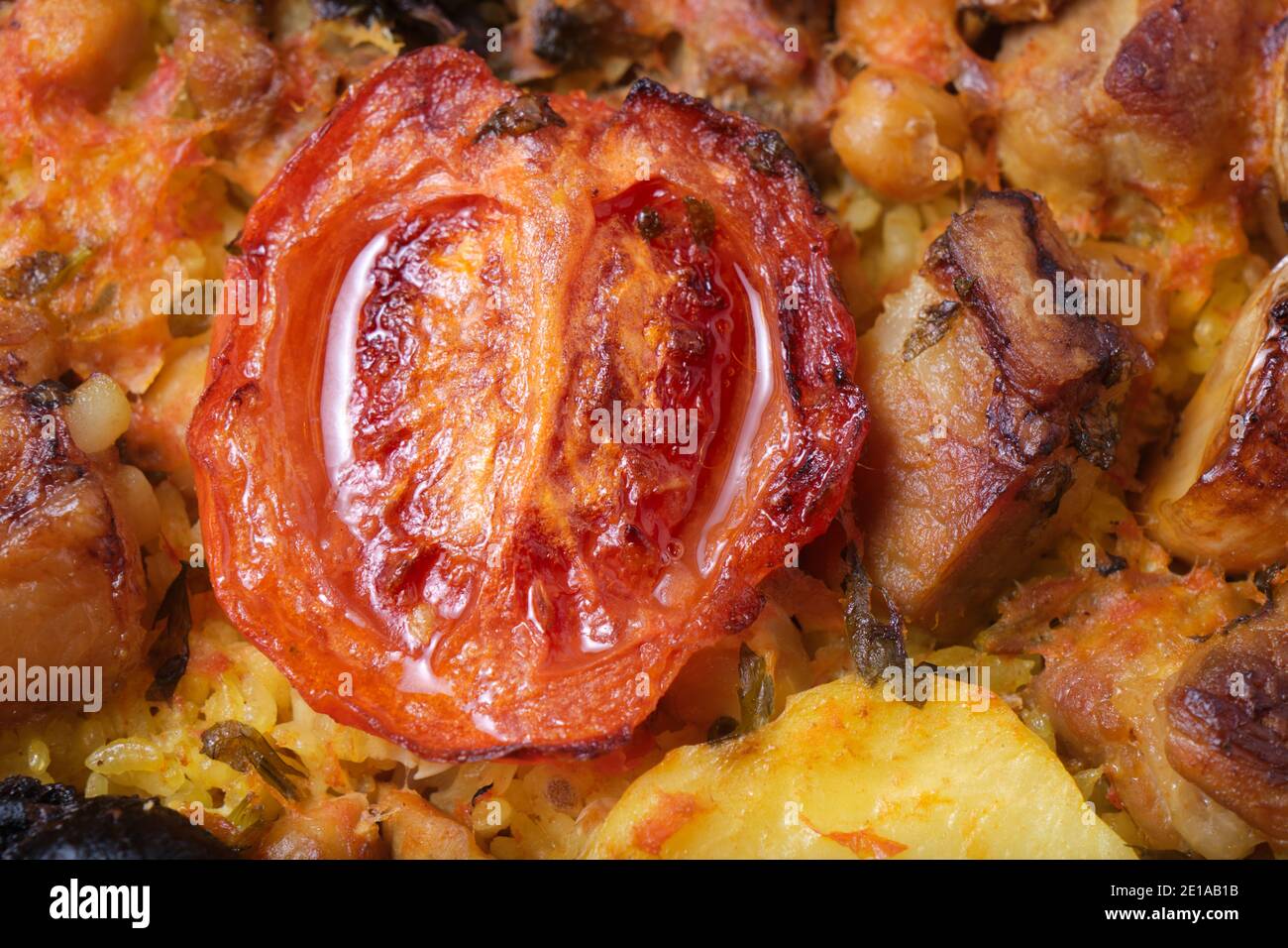 Foreground of roasted tomato with rice and meat. Stock Photo