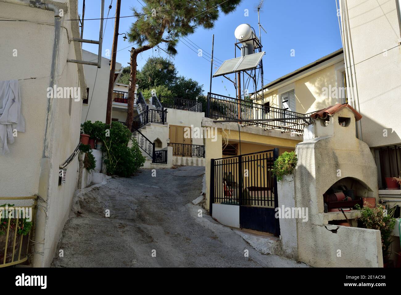 Small narrow steep street in village of Pissouri, Cyprus Stock Photo