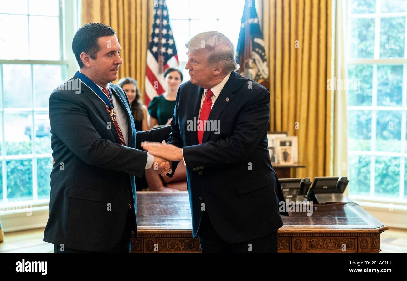 Washington, United States Of America. 04th Jan, 2021. U.S President Donald Trump congratulates Rep. Devin Nunes after awarding him the Medal of Freedom in an Oval Office ceremony at the White House January 4, 2021 in Washington, DC Credit: Planetpix/Alamy Live News Stock Photo