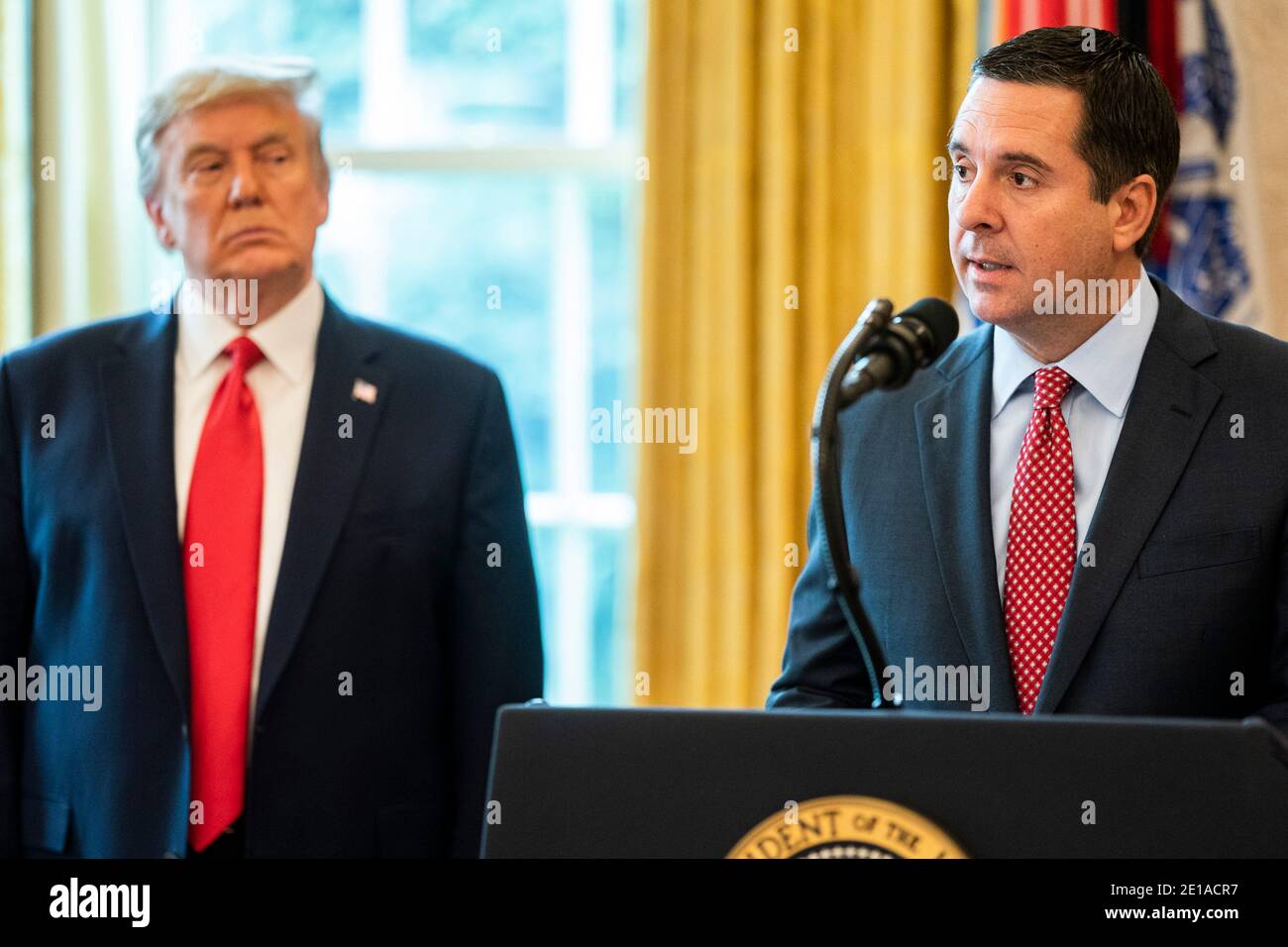 Washington, United States Of America. 04th Jan, 2021. U.S President Donald Trump listens as Rep. Devin Nunes, right, delivers remarks at the Medal of Freedom ceremony in the Oval Office at the White House January 4, 2021 in Washington, DC Credit: Planetpix/Alamy Live News Stock Photo