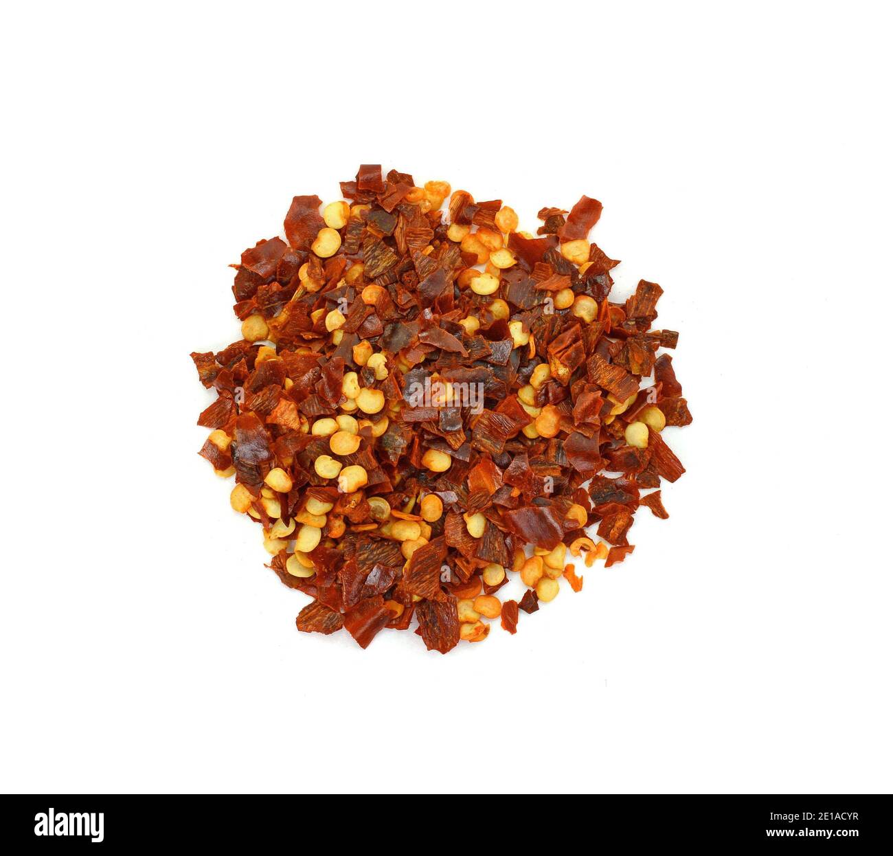 Cayenne pepper. Pile crushed red cayenne pepper, dried chili flakes and seeds isolated on white