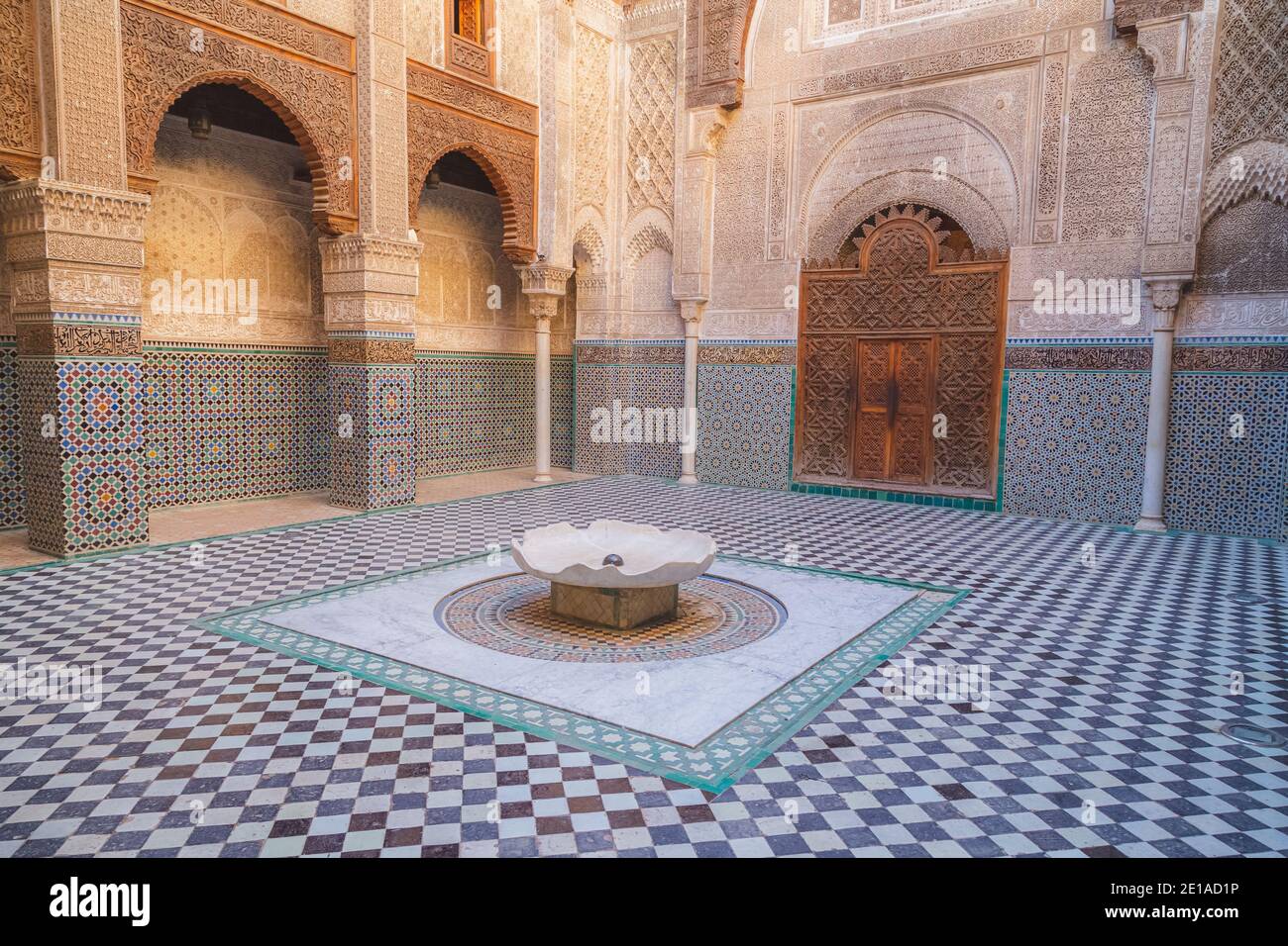 Fez, Morocco - November 26 2015: The interior courtyard of  this historic 14th century Al-Attarine Madrasa in the medina of Fez, Morocco. Stock Photo