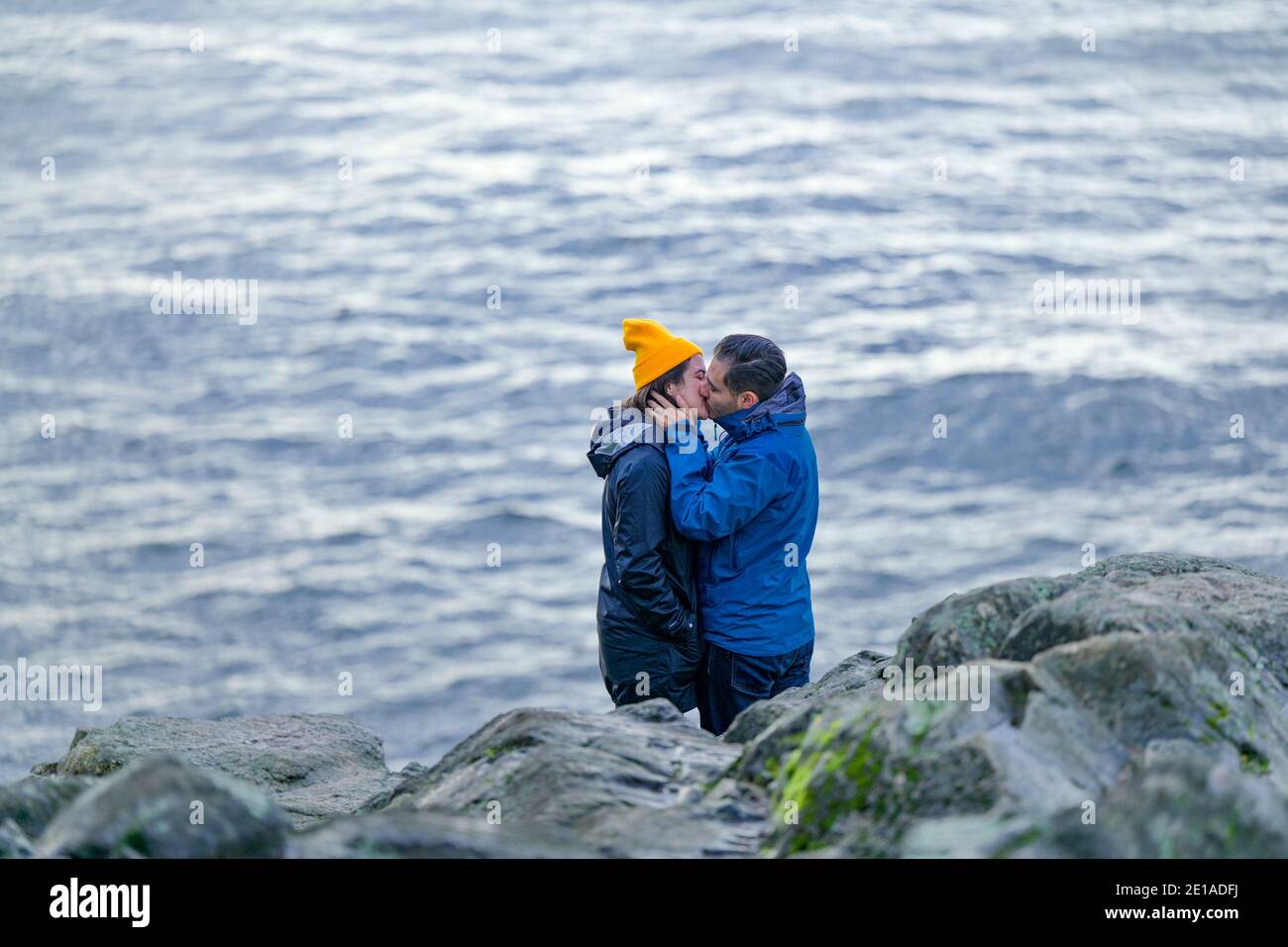 Couple kissing beside ocean Stock Photo