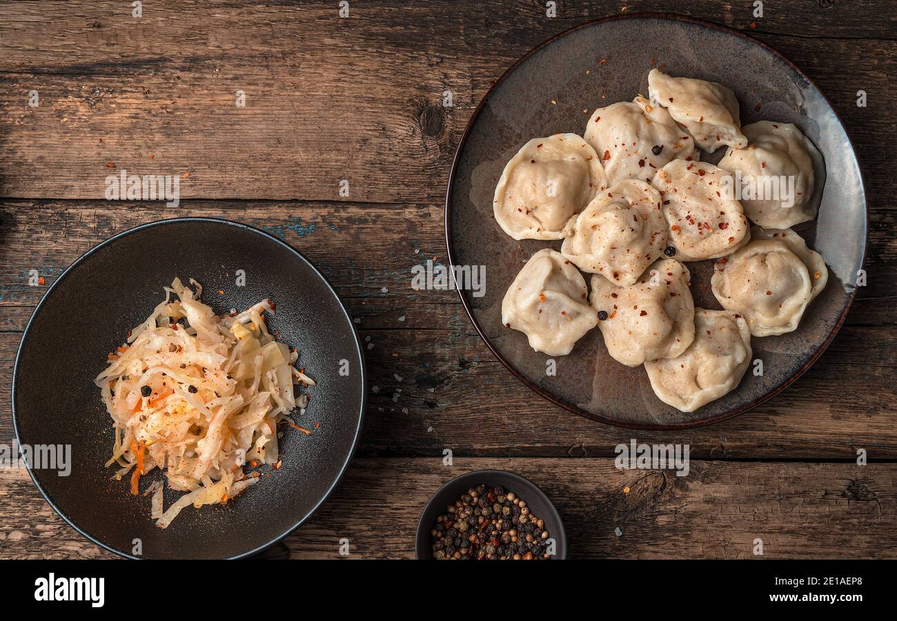 Scrambled eggs and dumplings on a wooden background. Stock Photo