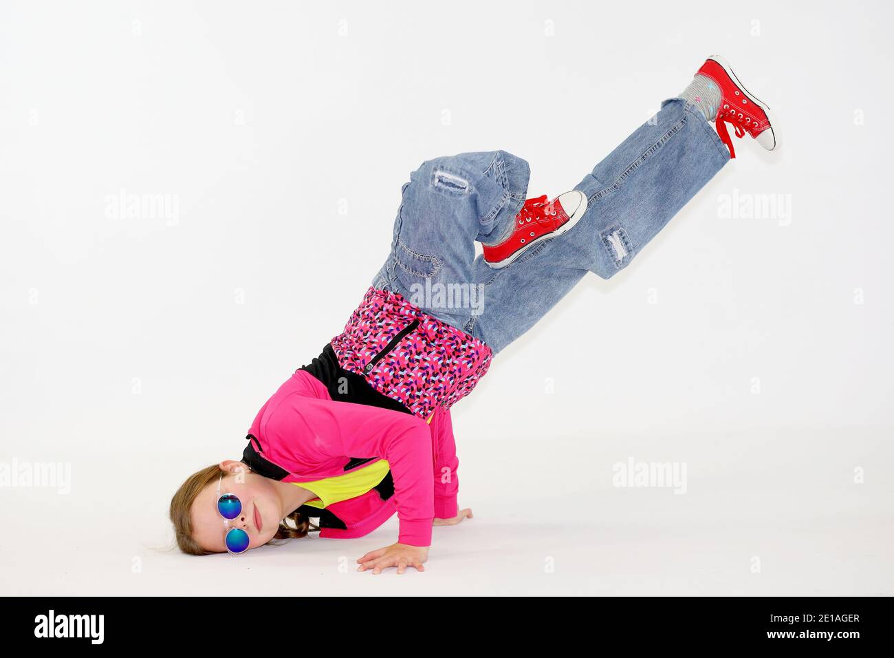 little girl in a difficult breakdance position Stock Photo