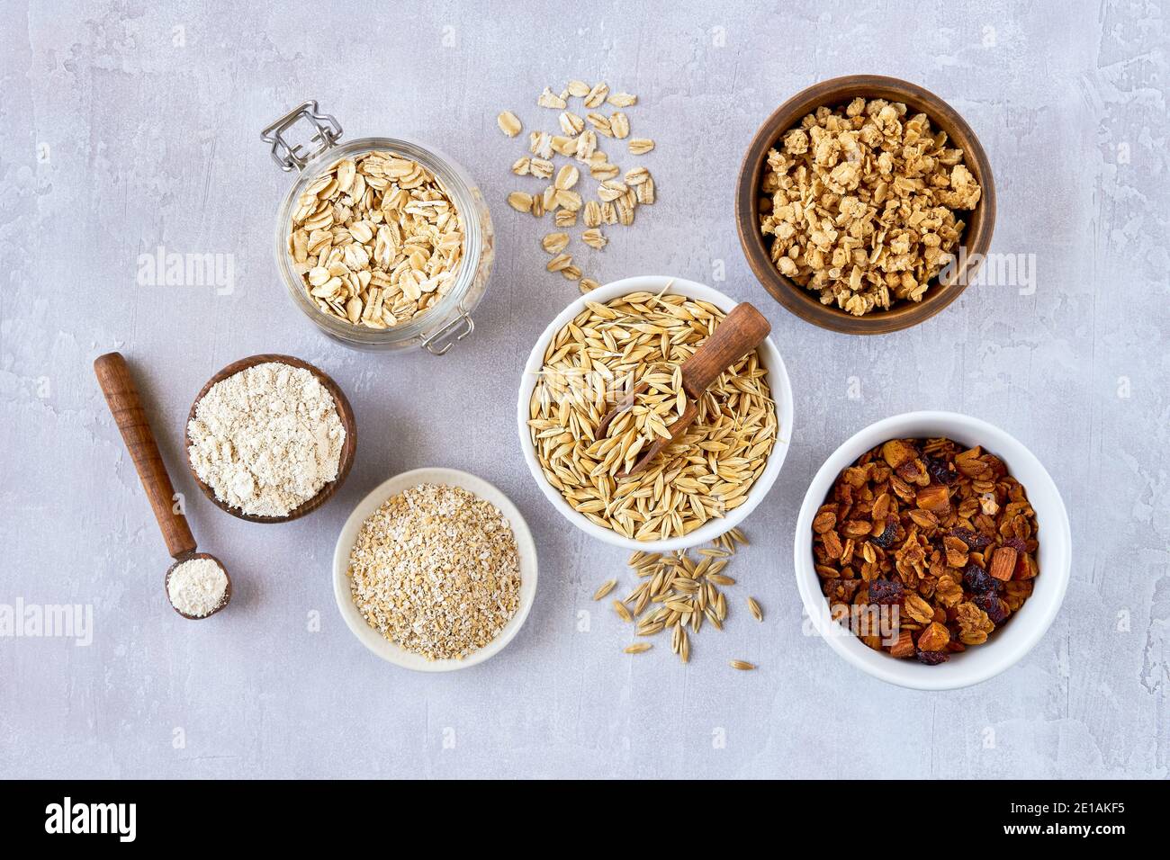 Oat products assortment in bowls. Granola, rolled oats, bran , flour