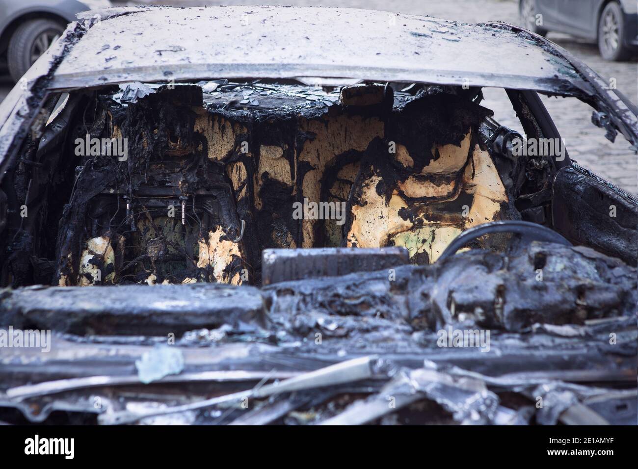 Burnt car closeup, front view with seats. Car after the fire. Arson car. Accident on the road