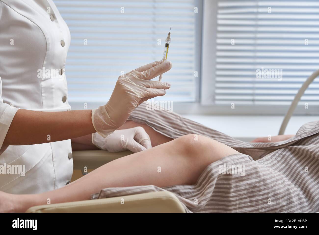 Gynecologist with syringe makes an injection to patient in gynecology ...