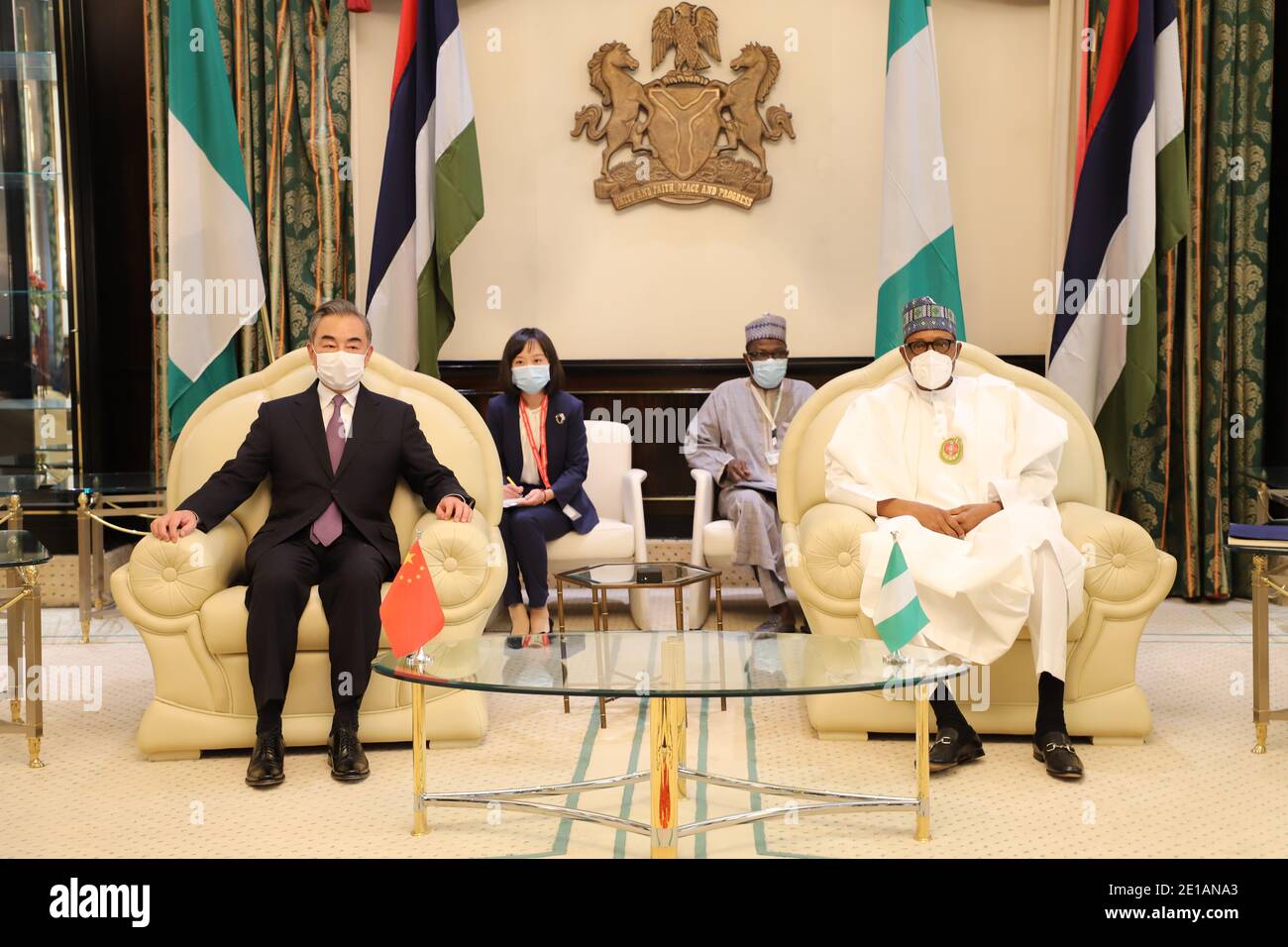 Abuja, Nigeria. 5th Jan, 2021. Nigerian President Muhammadu Buhari (1st R) meets with visiting Chinese State Councilor and Foreign Minister Wang Yi (1st L) in Abuja, Nigeria, on Jan. 5, 2021. Credit: Jiang Xuan/Xinhua/Alamy Live News Stock Photo