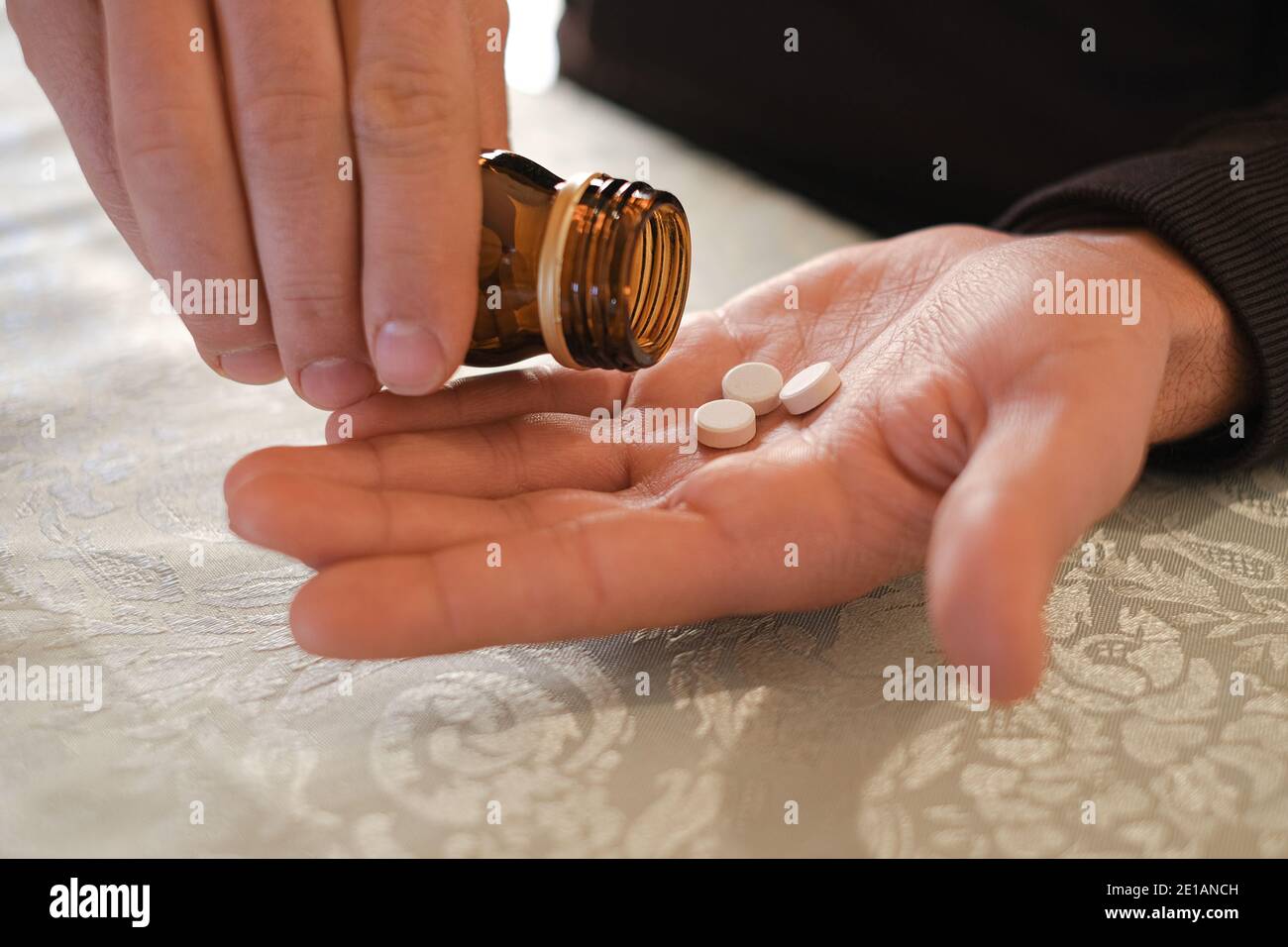 Man taking medicine pills for daily illness home treatment,healthy lifestyle Stock Photo