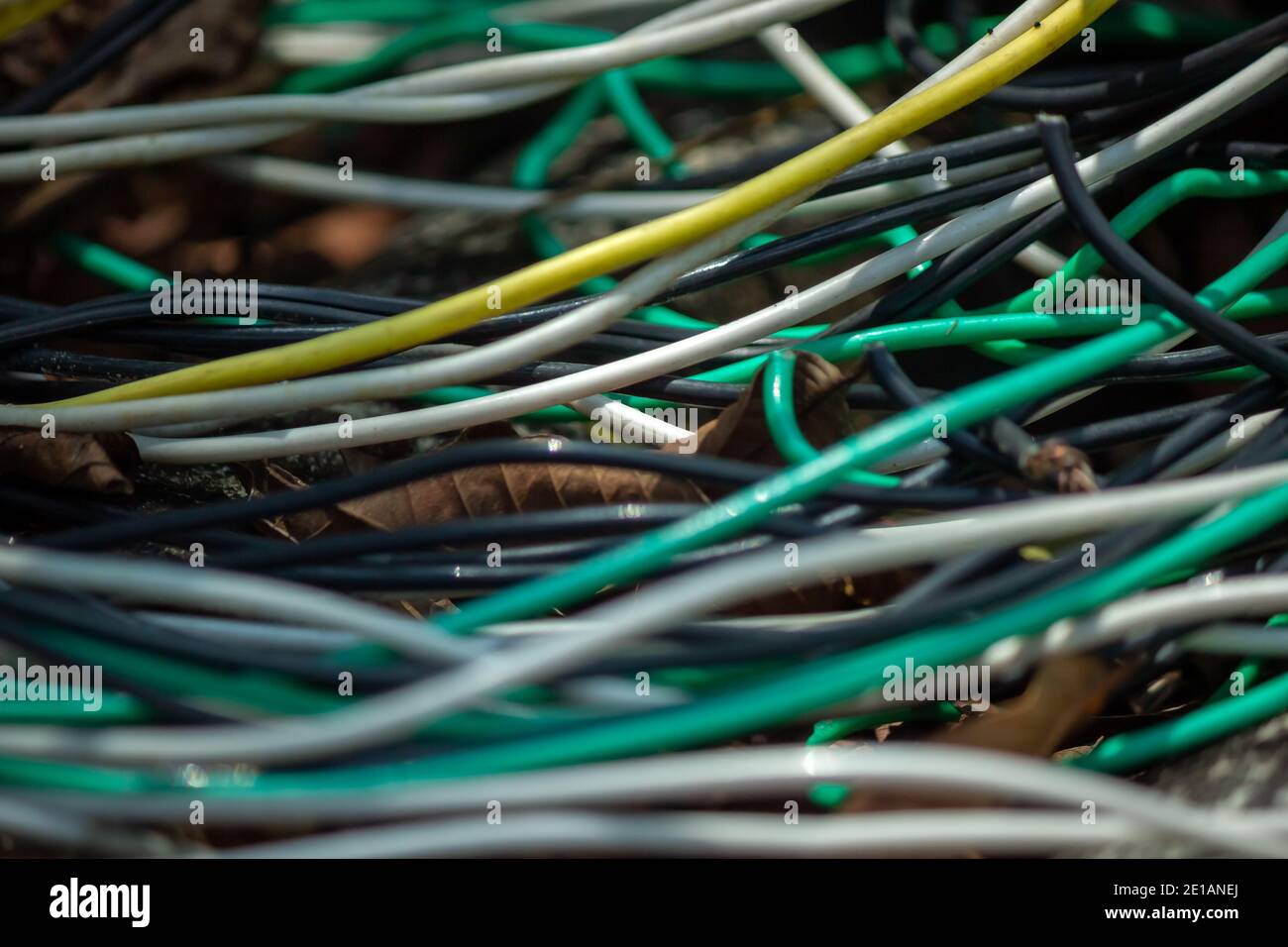 Closeup of several electrical wires forming curved lines with a lot of chaos like if they were abandoned Stock Photo
