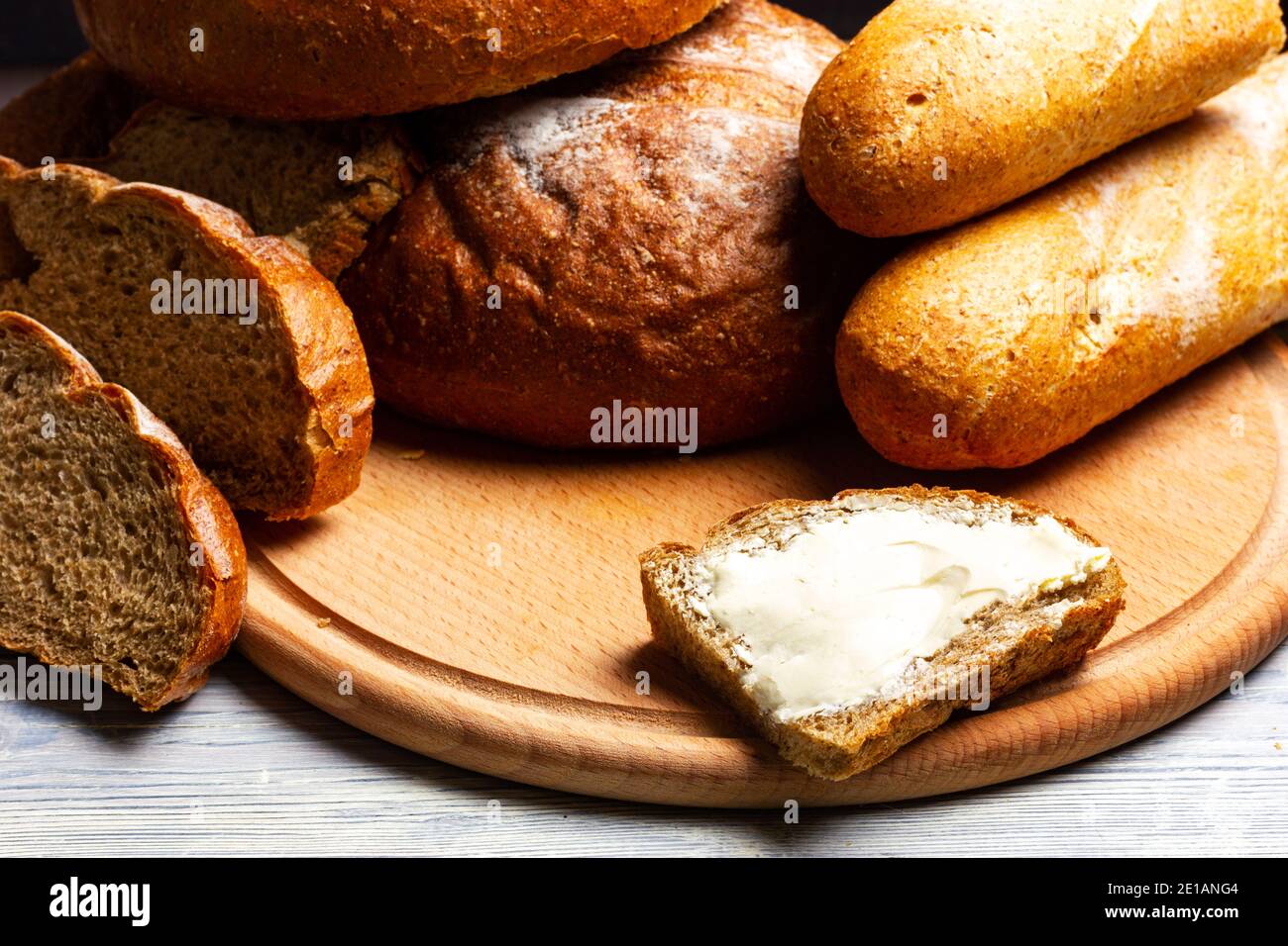 Rye bread and butter sandwich on a wooden table. Still life in rustic style. Stock Photo
