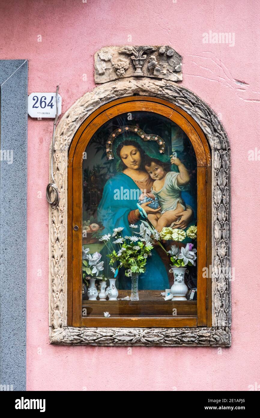 Votive shrine of Virgin Mary on a house wall, Zafferana Etnea, Italy Stock Photo