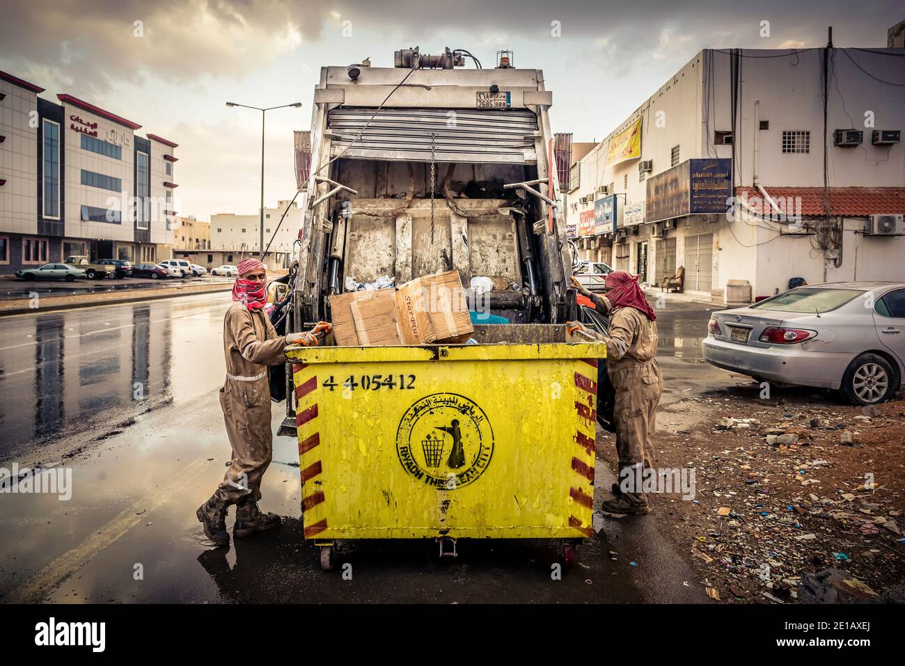 Garbage pick-up on rainy morning Stock Photo