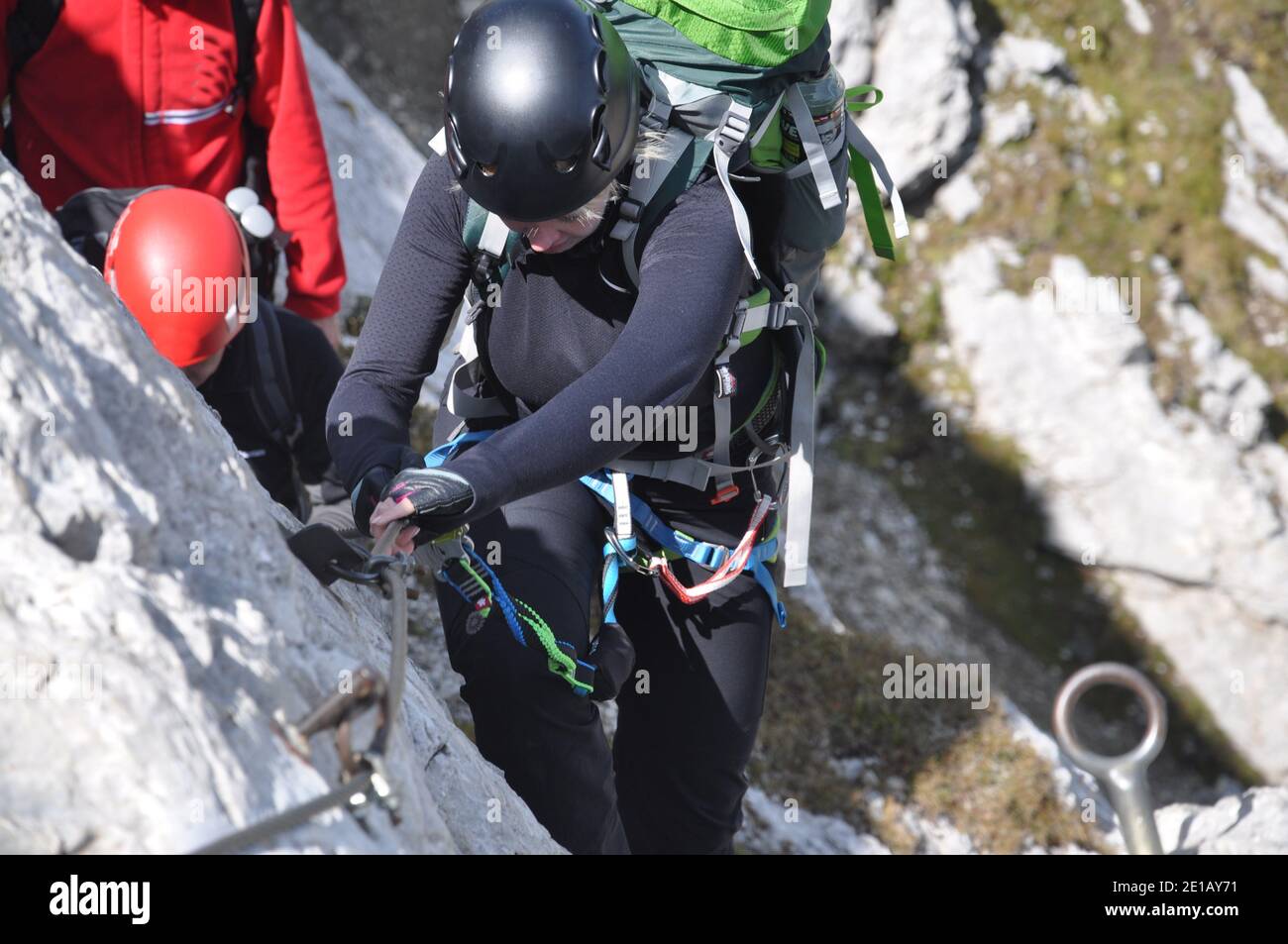 People climbing in via ferrata in Dolomites, Italy Stock Photo