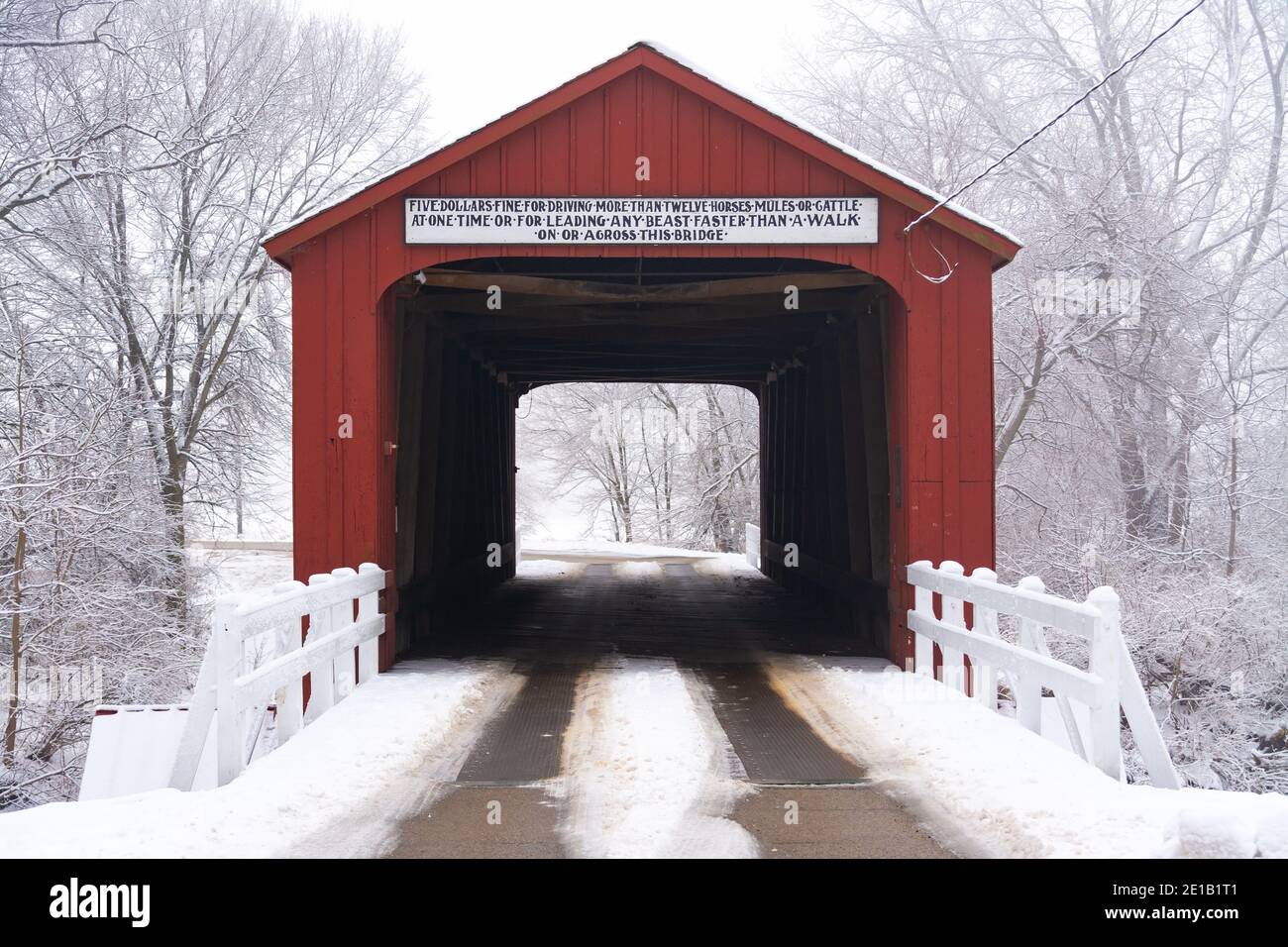 Red Covered Bridge in rural Illinois on a foggy Winter morning.  Princeton, Illinois. Stock Photo