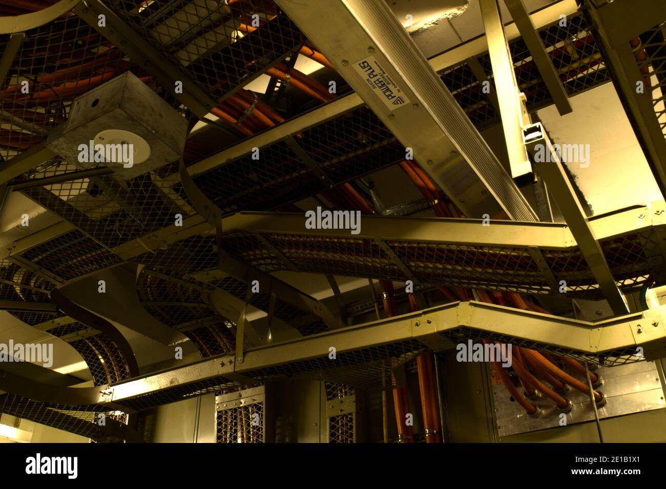 Overhead/ceiling IT Network and Comms cabling in Lower Basement of an old, 25+ story city building (c.1970's). Stock Photo