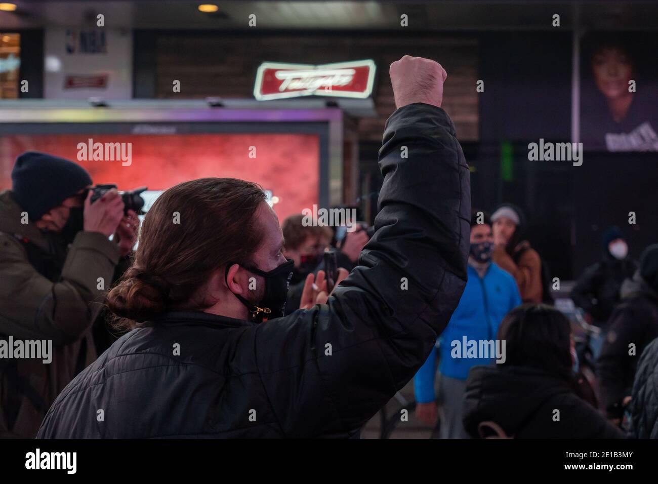 NEW YORK, NY - JANUARY 5: A protestor rise his fist as protester gather in Times Square on January 5, 2021 in New York City.  A small group of 20 protestors march after the announcement in the Jacob Blake case.  Kenosha County District Attorney Michael Graveley announced Tuesday that Rusten Sheskey, a White Police Officer, who shot Jacob Blake, a 29-year-old Black man, seven times in the back while responding to a domestic incident on August 23, 2020, will not face charges in the shooting. Credit: Ron Adar/Alamy Live News Stock Photo