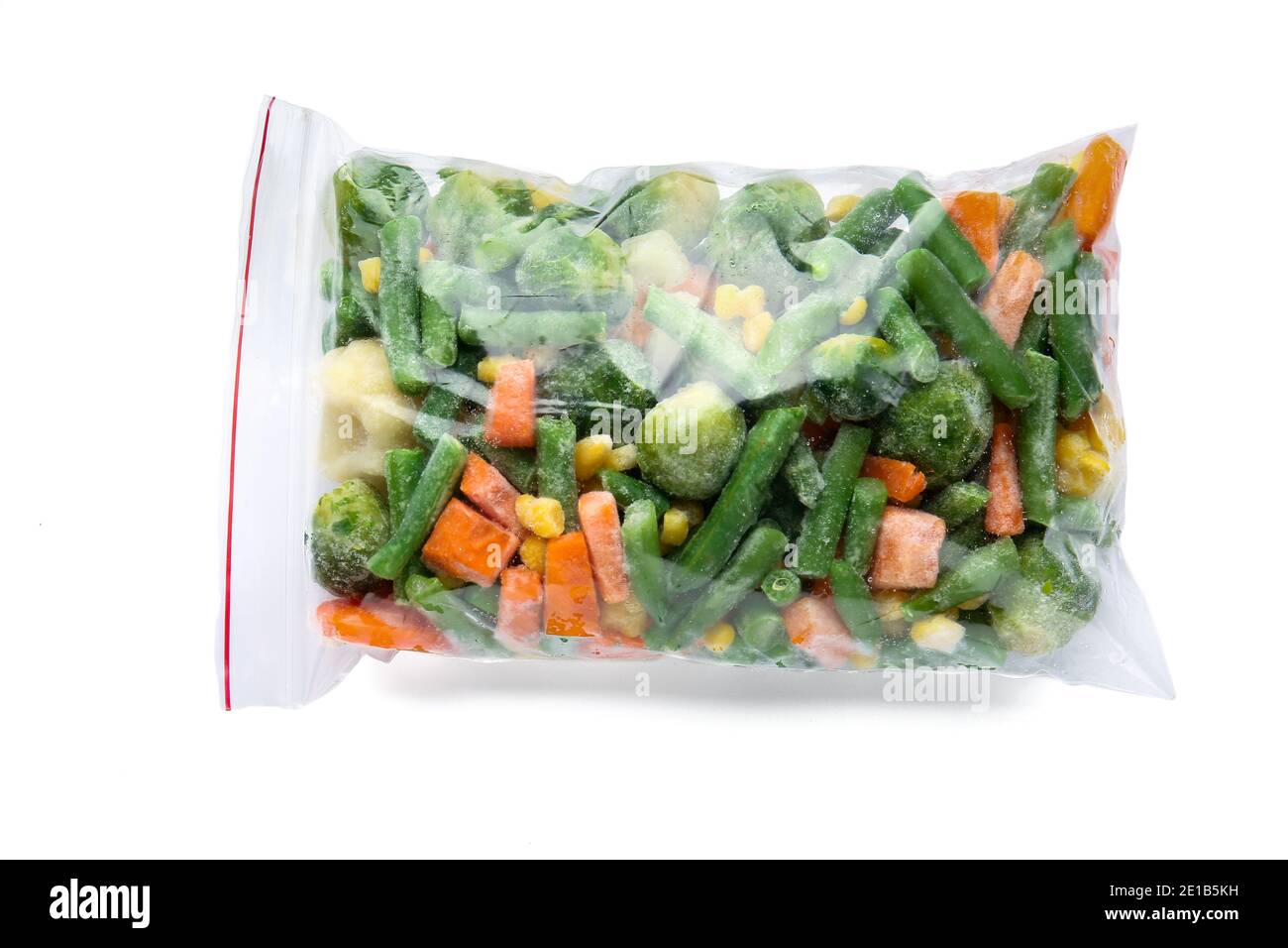 Frozen vegetables in plastic bag on white background Stock Photo - Alamy