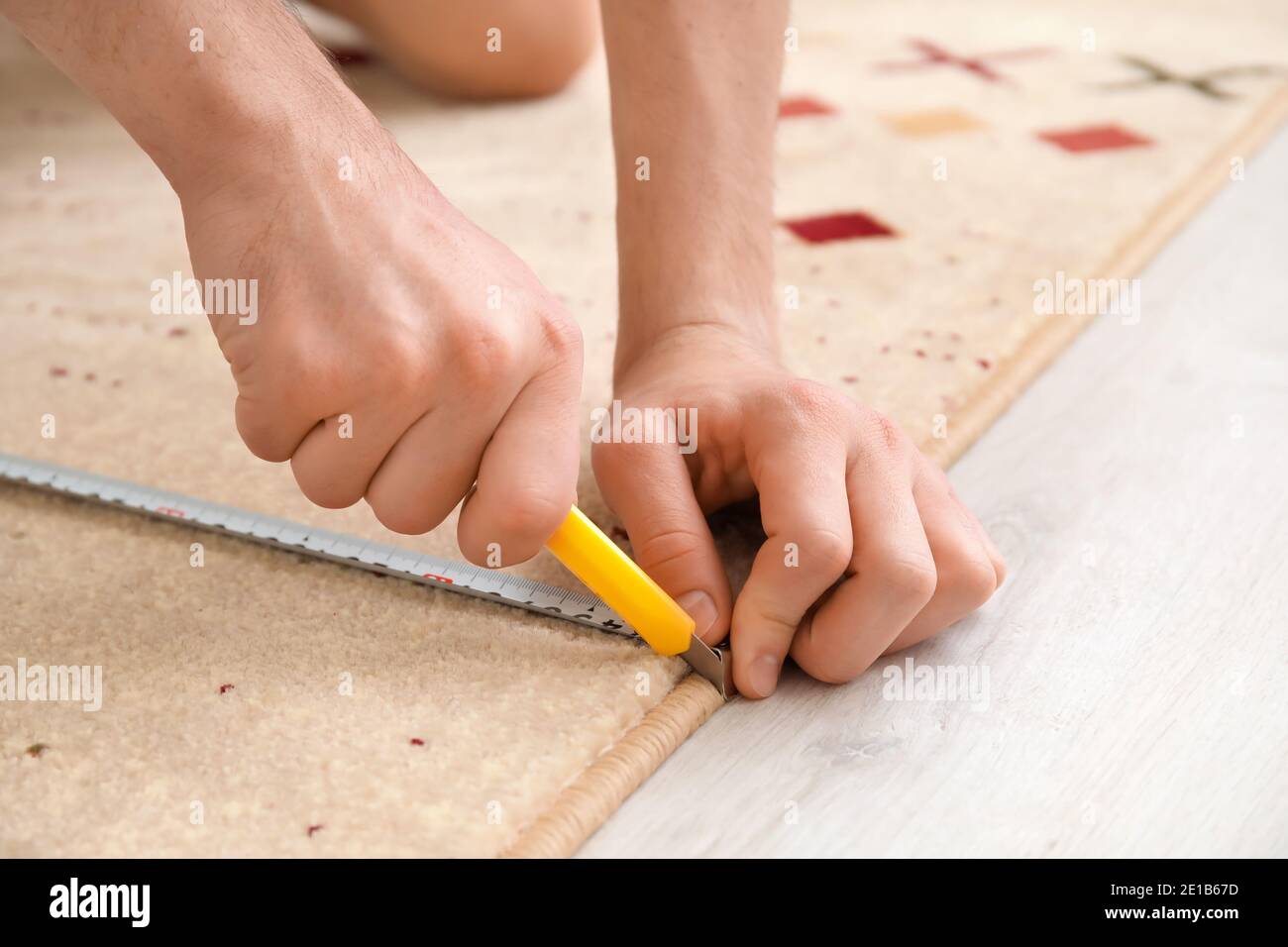 Man with measuring tape cutting carpet Stock Photo Alamy