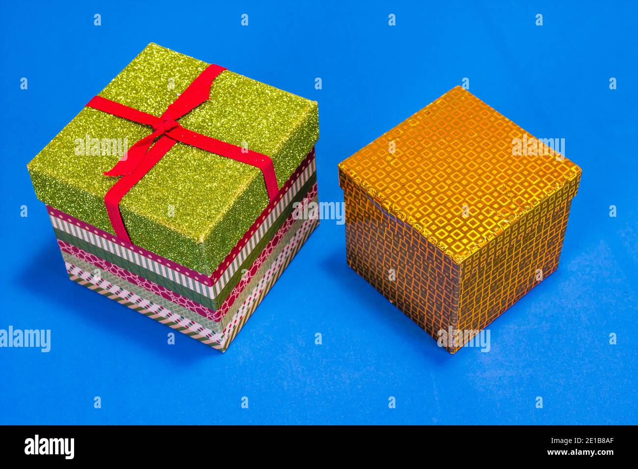 Two Christmas Gift Boxes On Blue Background Stock Photo
