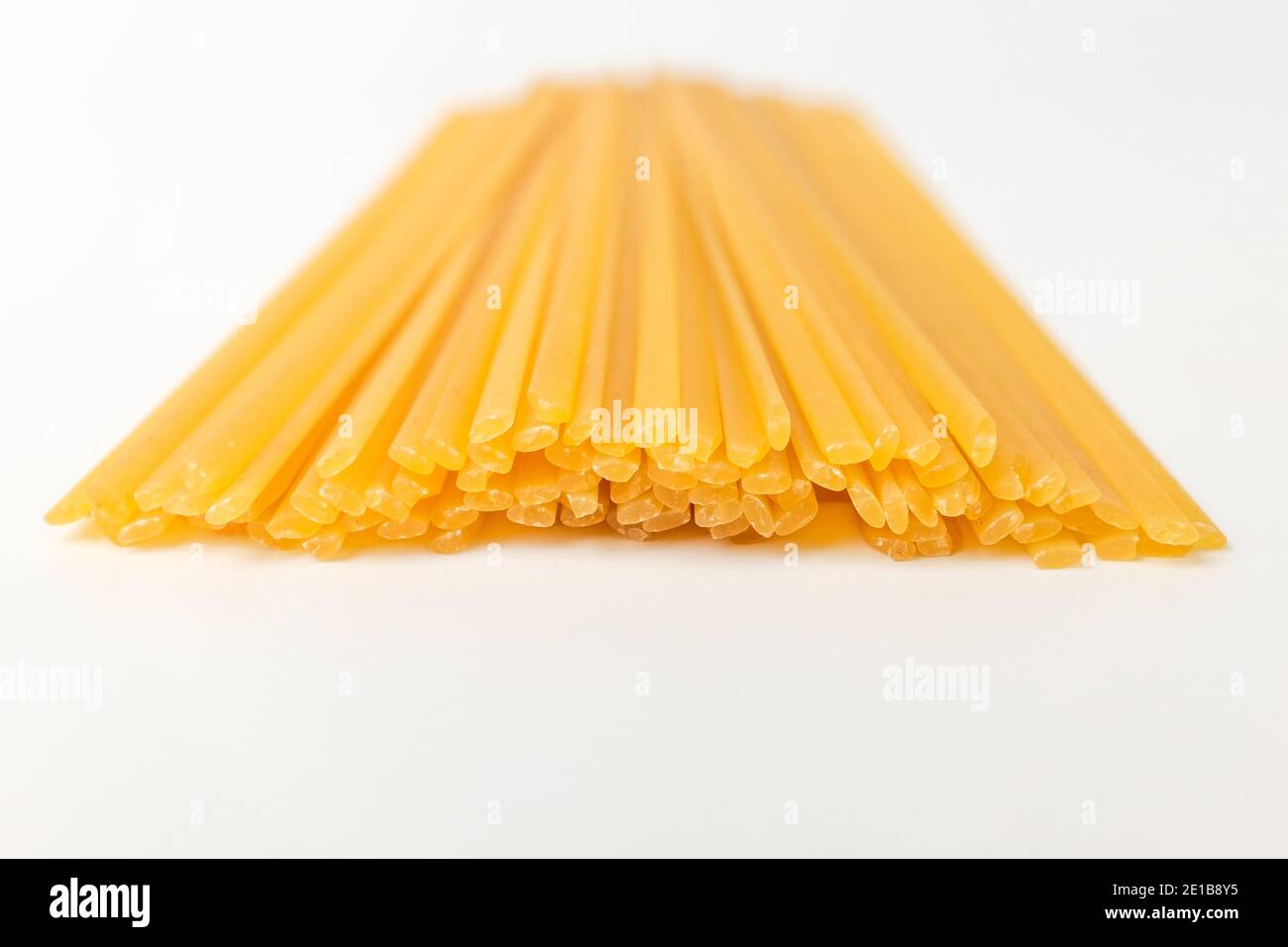 Italian pasta noodles. Flat and thin pasta. Yellow linguini pasta Stock