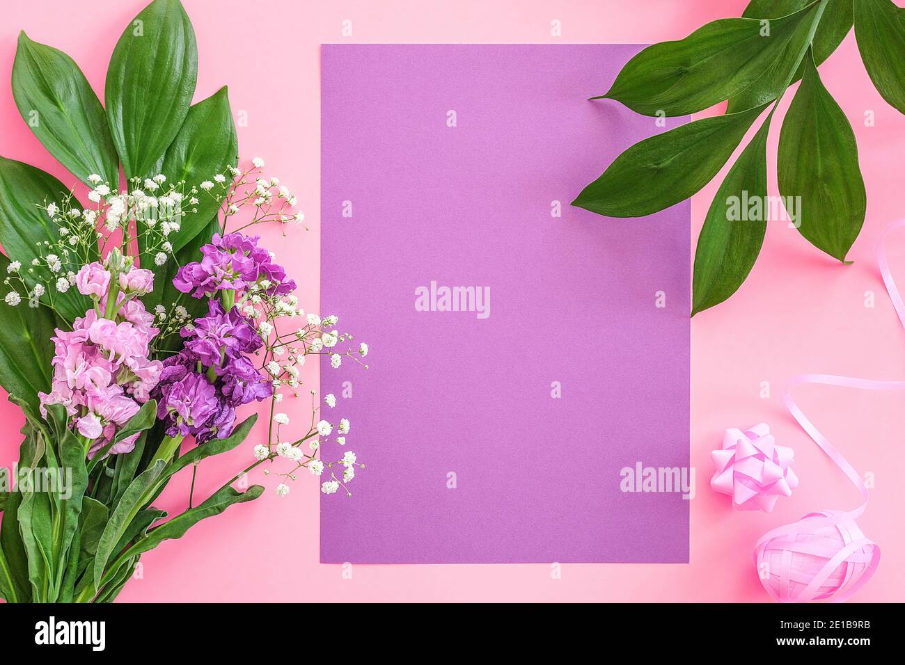 Bouquet flowers on pink purple background. Greeting card Flat Lay Copy space Concept Hello spring, Mother's day, Womens day, Good day Template for tex Stock Photo