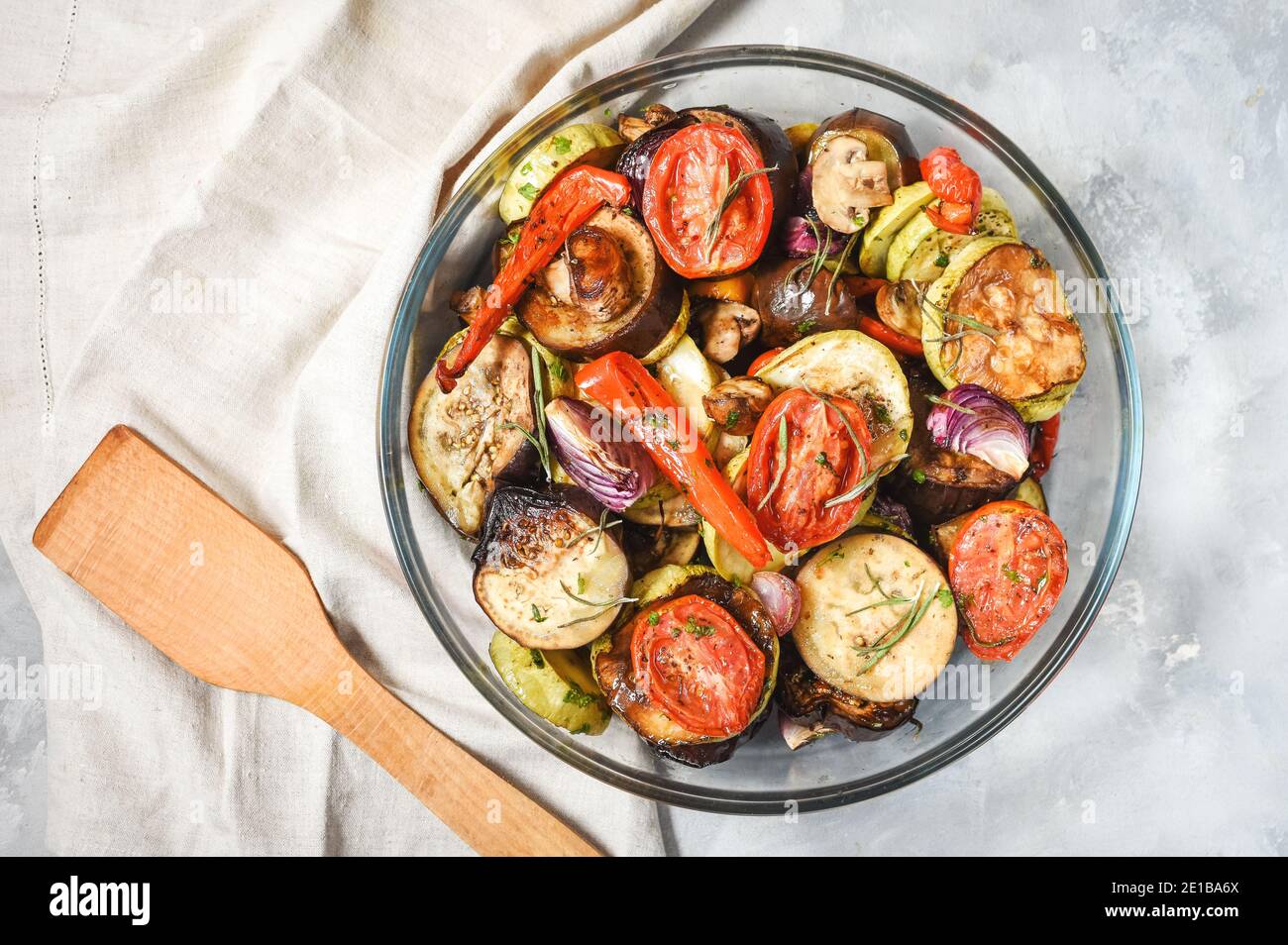 Roasted vegetables mix on plate on concrete background. Top view Stock Photo