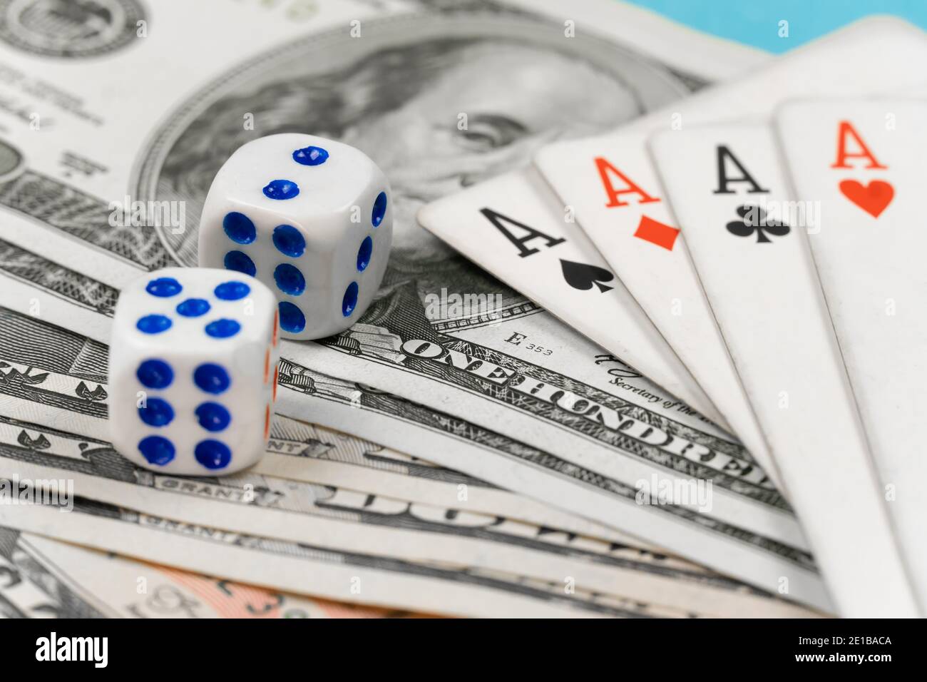 Dice, four aces lying on dollar bills close-up. Concept of playing poker Stock Photo