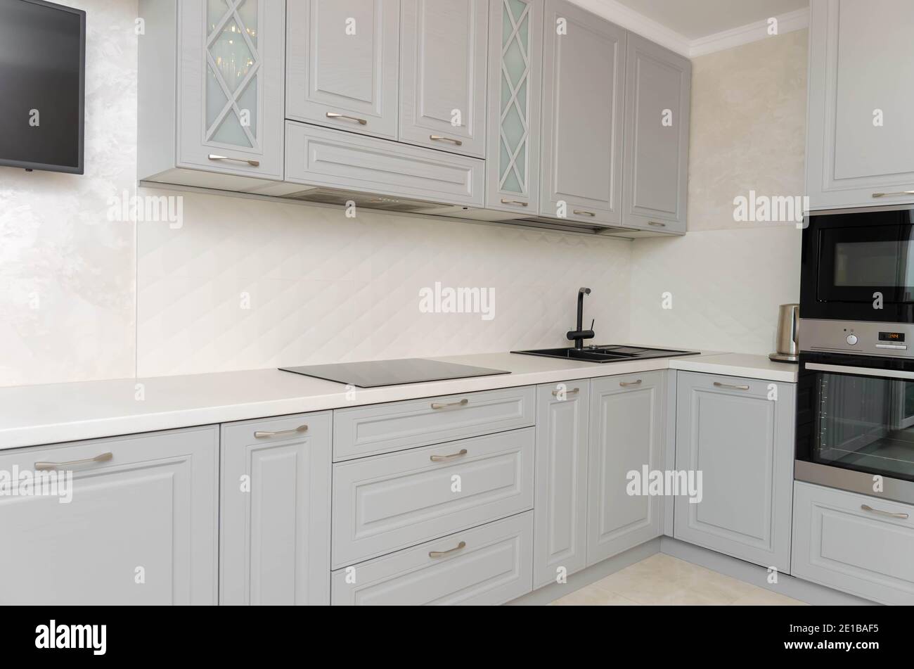 Beautiful classic kitchen in light gray, white tones in a new house