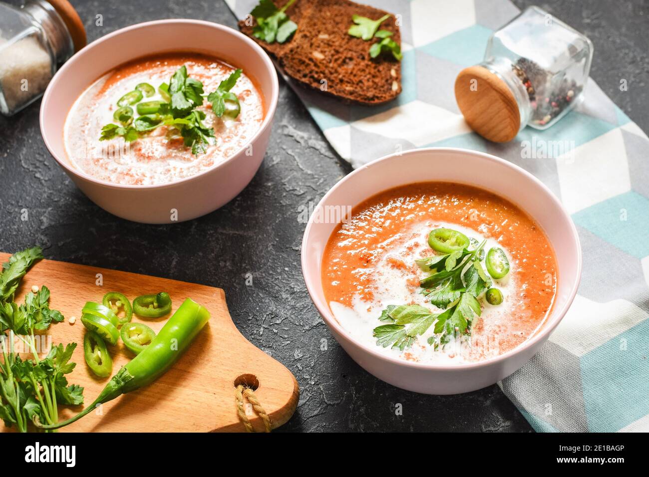 Red lentil tomato soup - delicious vegetarian food on black stone background. Healthy lunch Stock Photo
