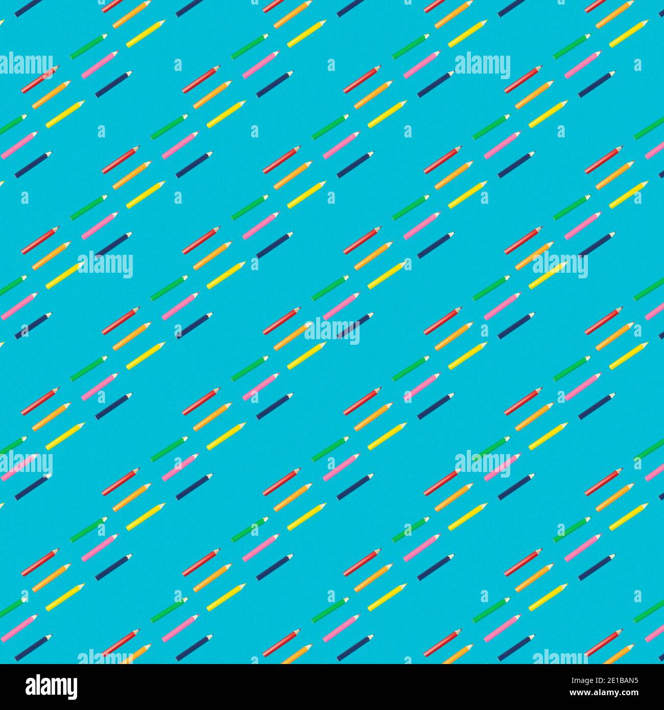 Seamless pattern of colored pencils on a blue background. Square pattern Stock Photo