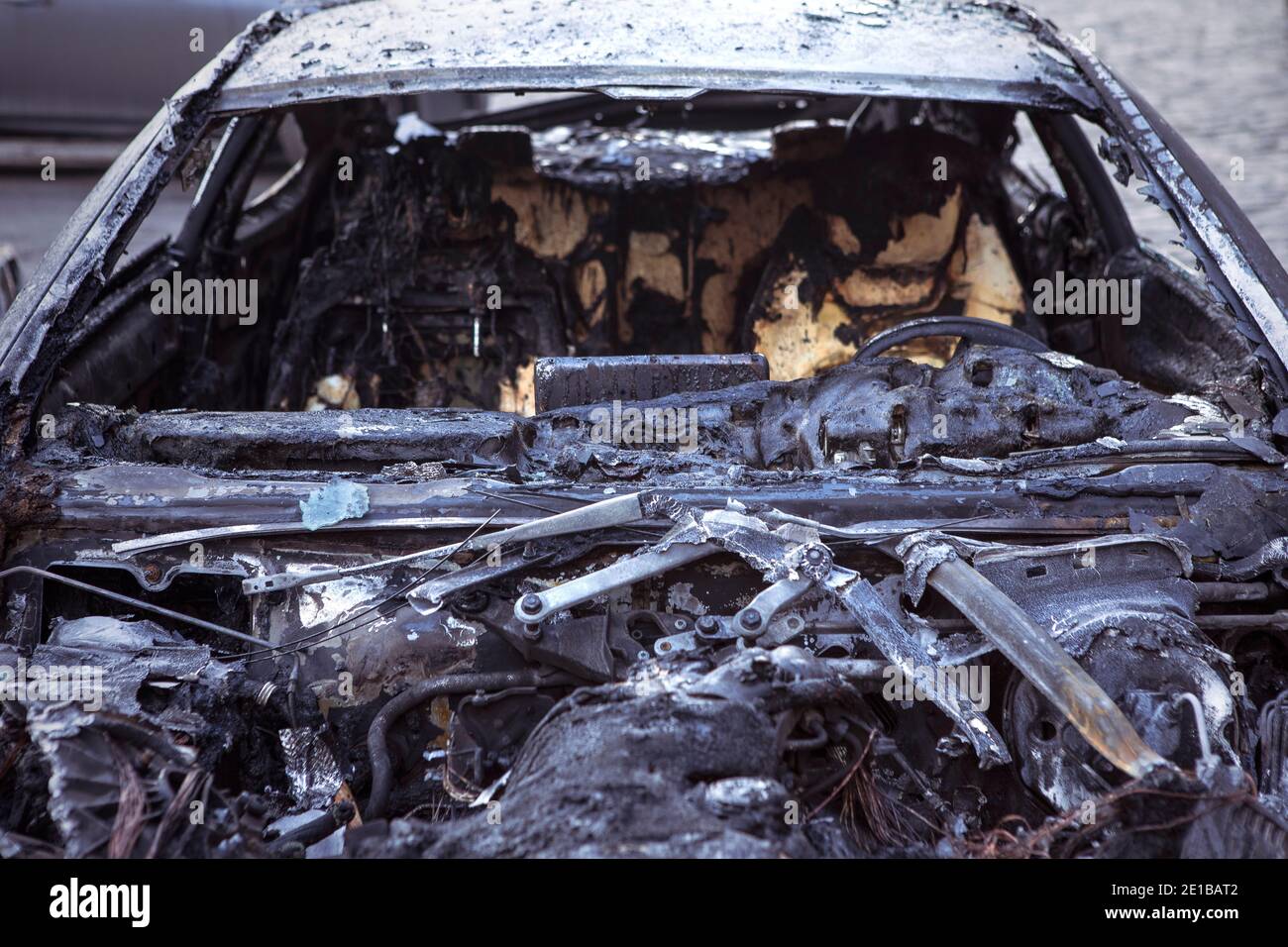 Burnt car closeup, front view with seats. Car after the fire. Arson